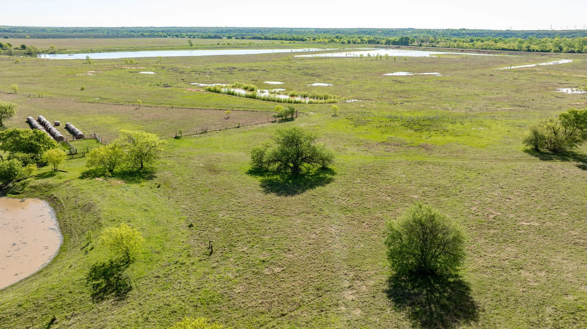 Birds eye view of property featuring a water view and a rural view