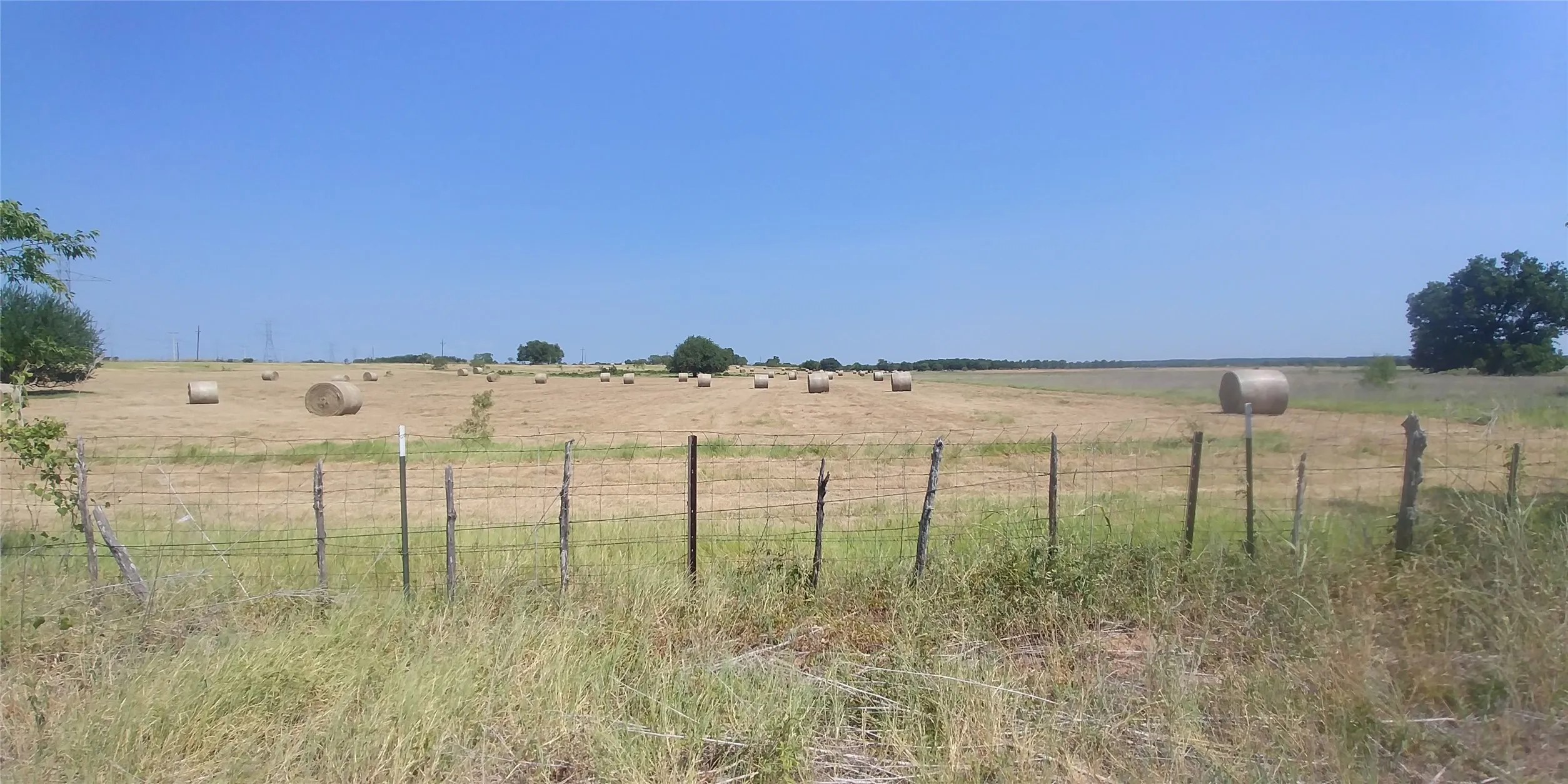 View of yard featuring fence and a rural view