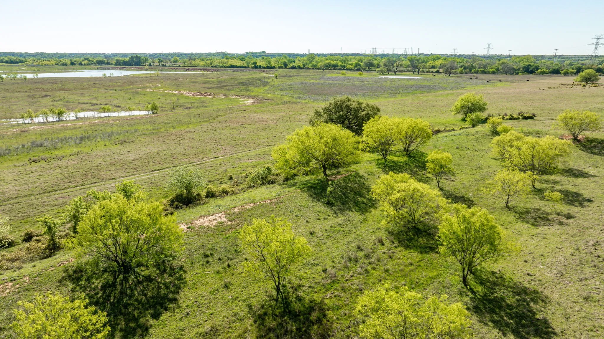 Birds eye view of property with a water view and a rural view