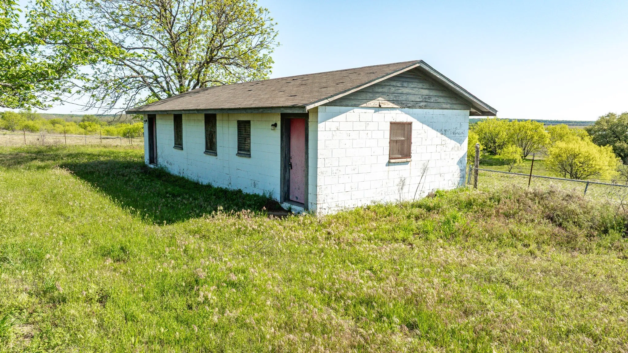View of outbuilding featuring fence and an outbuilding