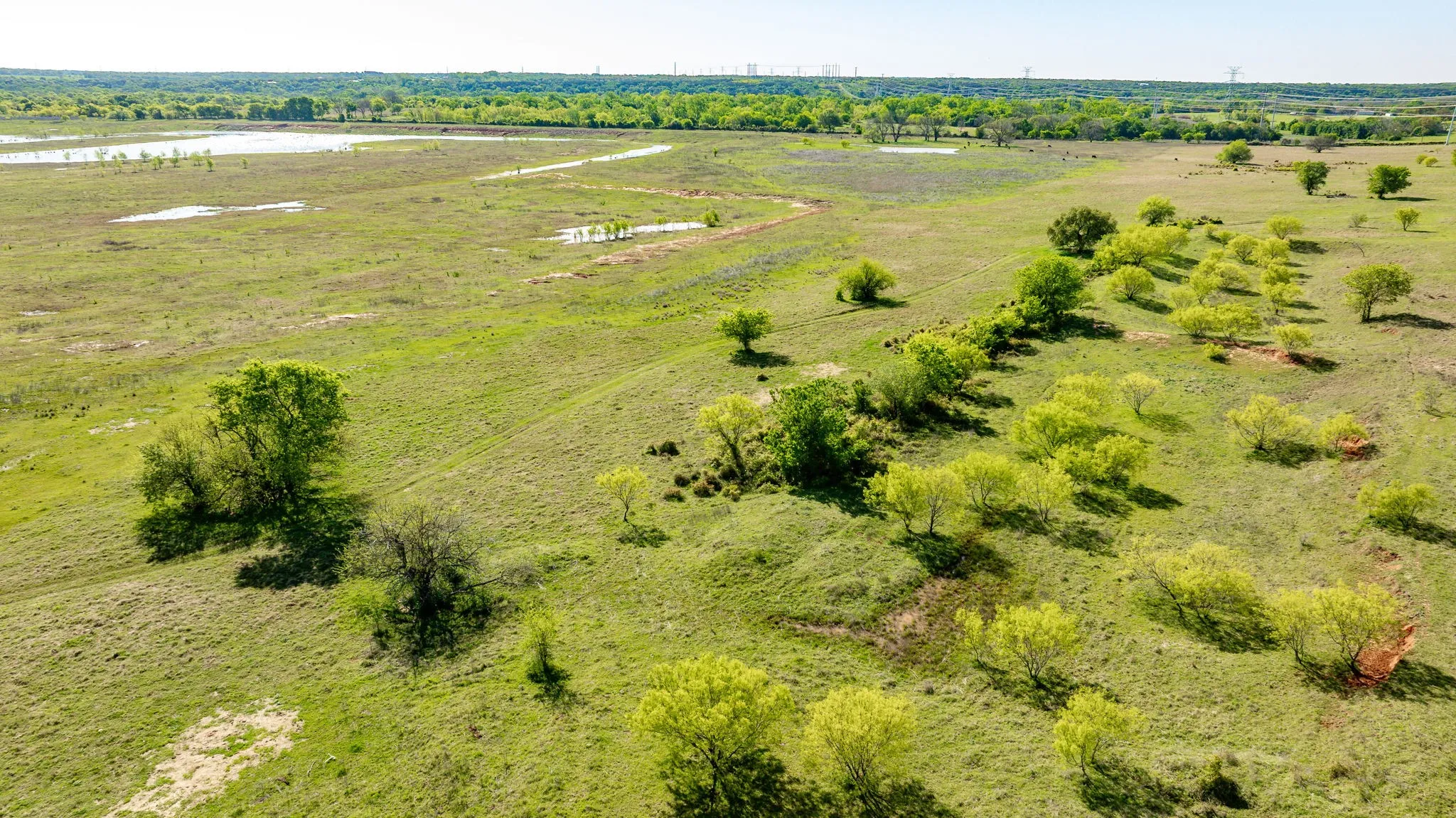 Birds eye view of property featuring a water view and a rural view