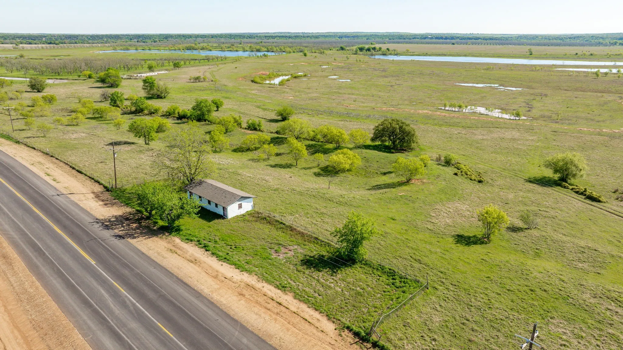 Drone / aerial view featuring a water view and a rural view