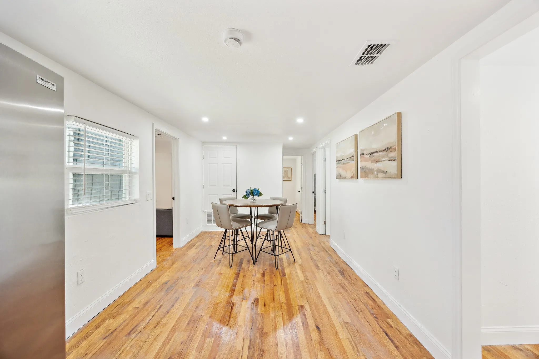 Dining space featuring light wood finished floors, baseboards, visible vents, and recessed lighting