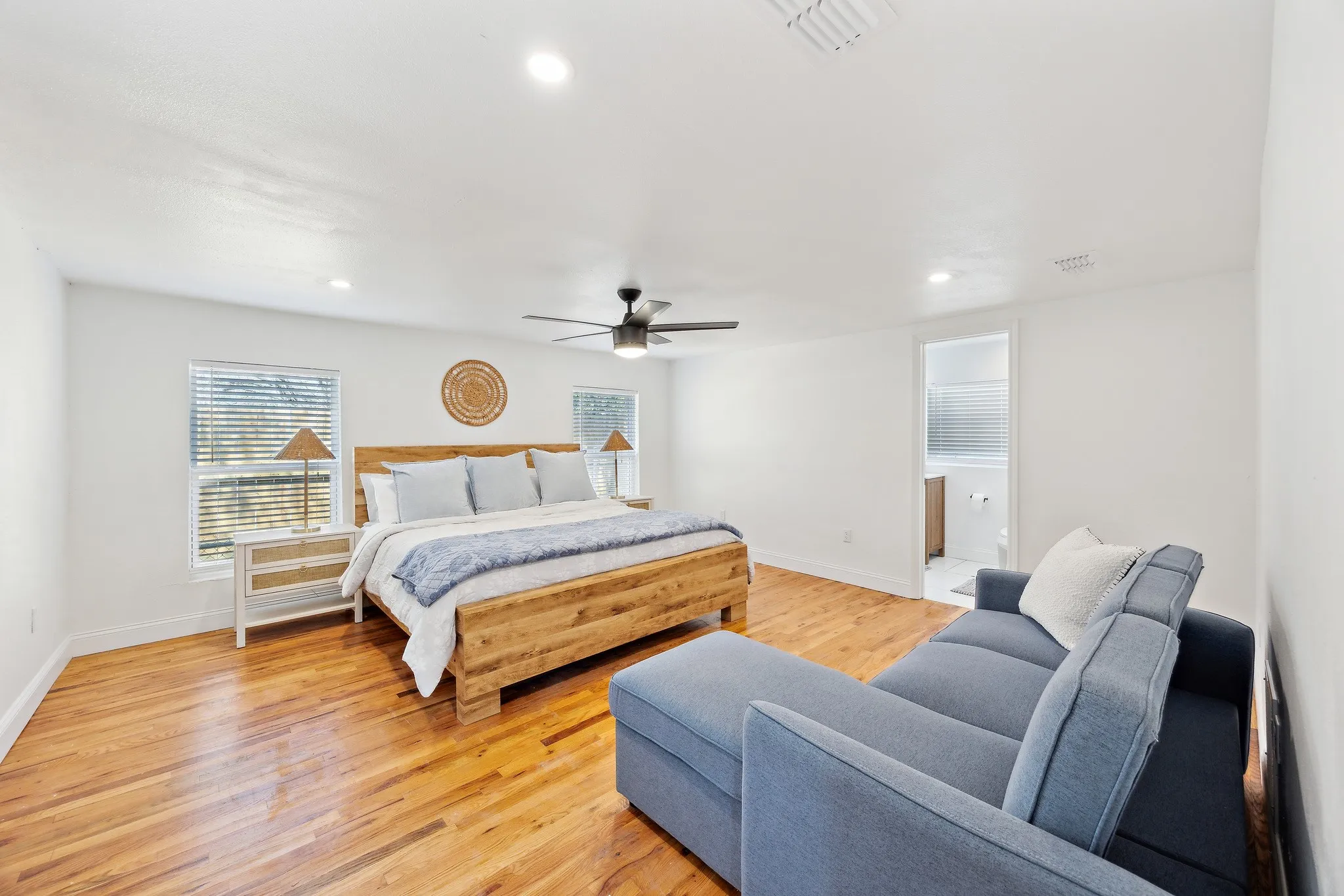 Bedroom with light wood-type flooring, baseboards, visible vents, and recessed lighting