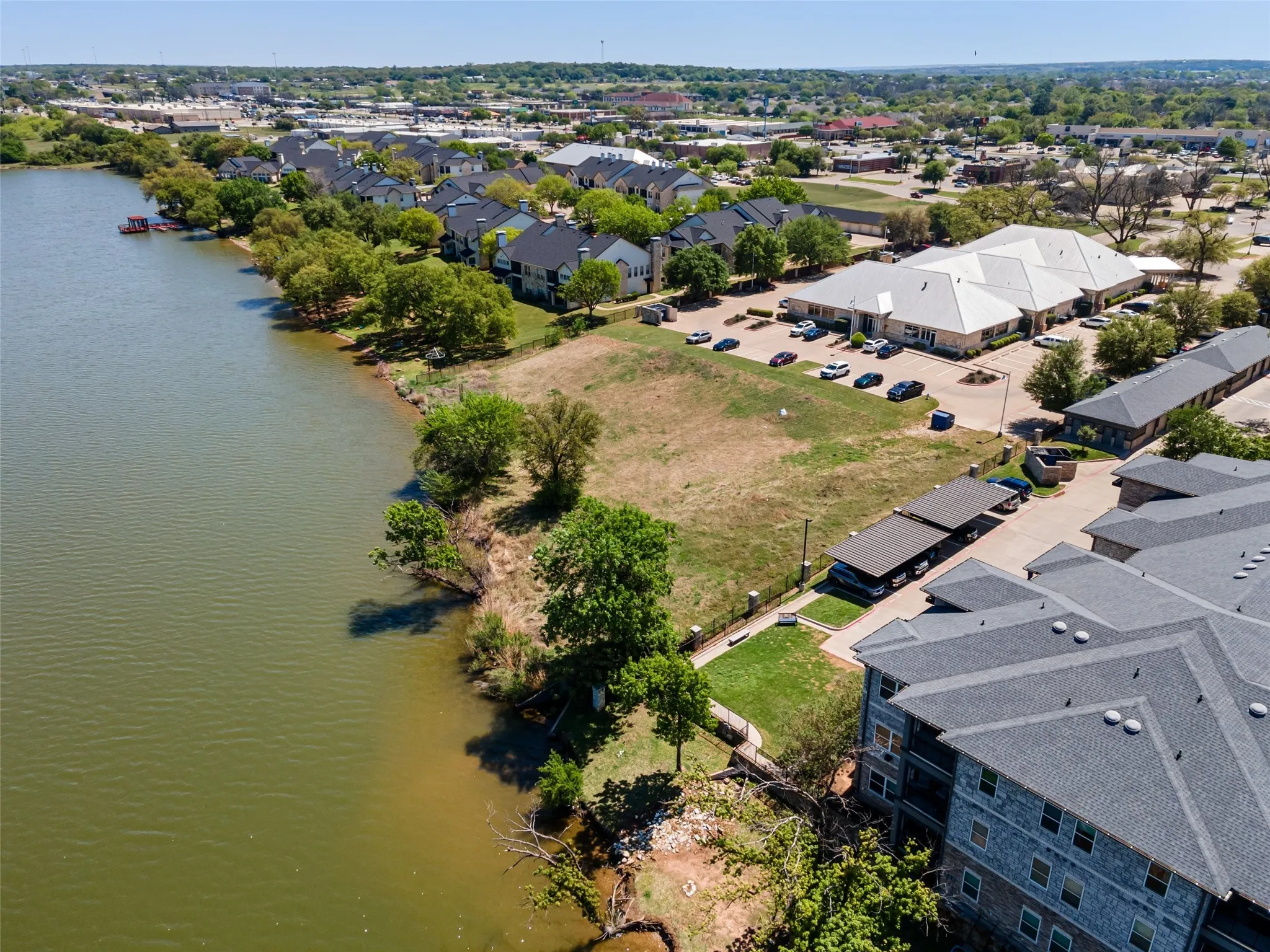 Aerial view featuring a water view and a residential view