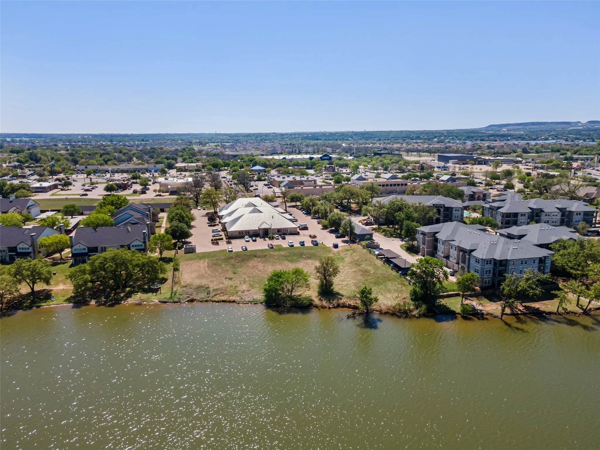 Birds eye view of property with a water view and a residential view