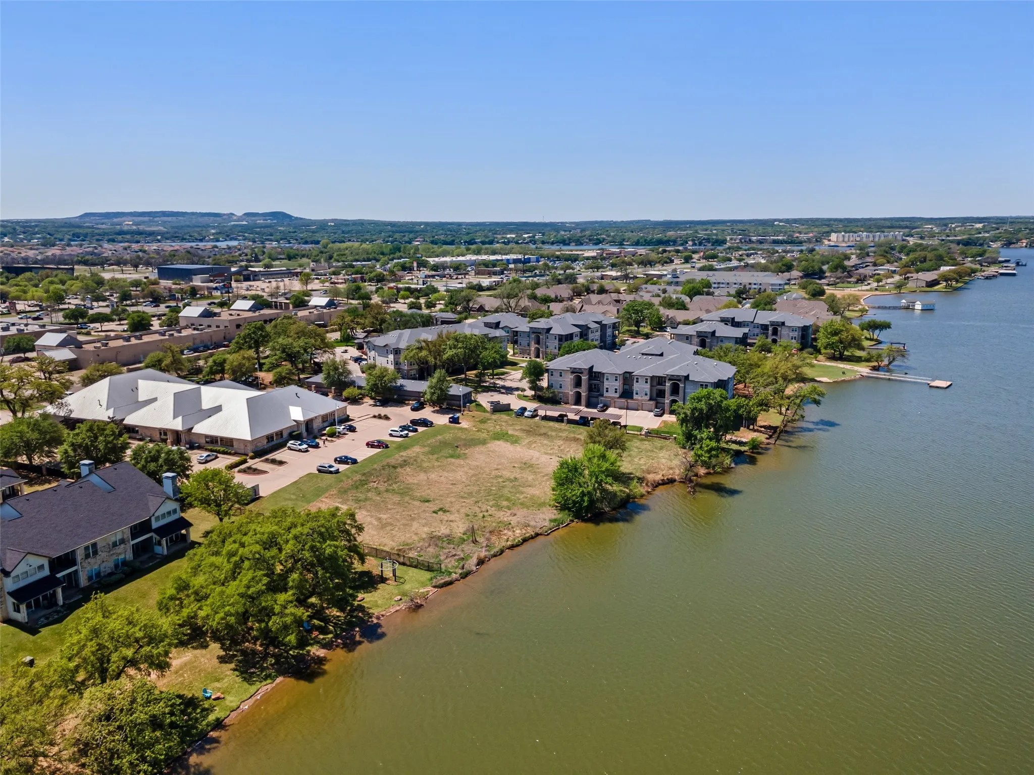 Birds eye view of property with a water view and a residential view