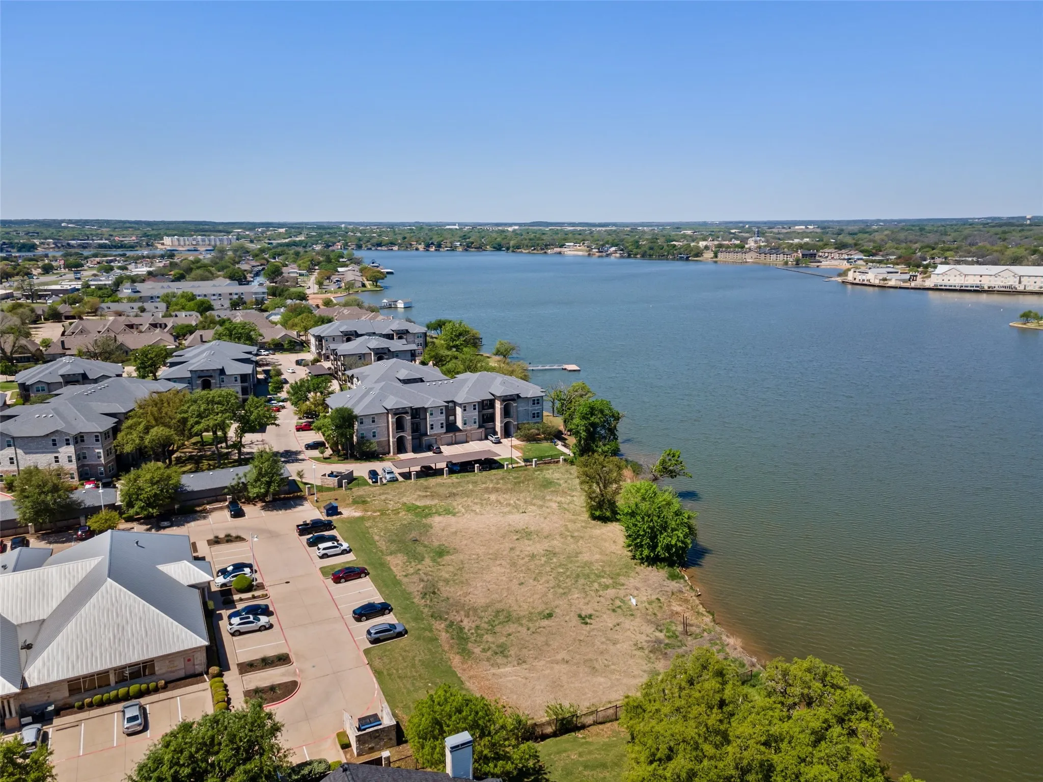 Birds eye view of property featuring a water view and a residential view