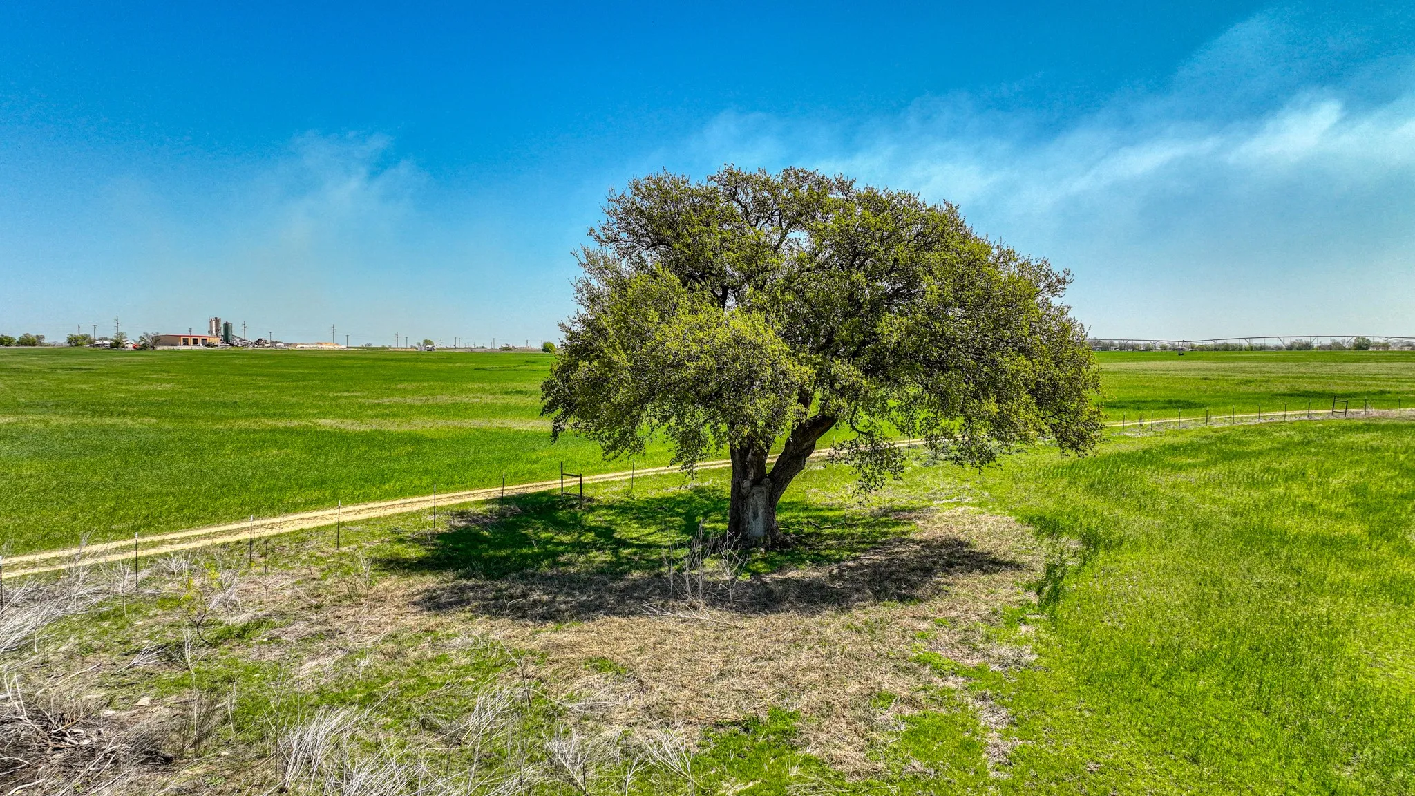 View of yard with fence and a rural view