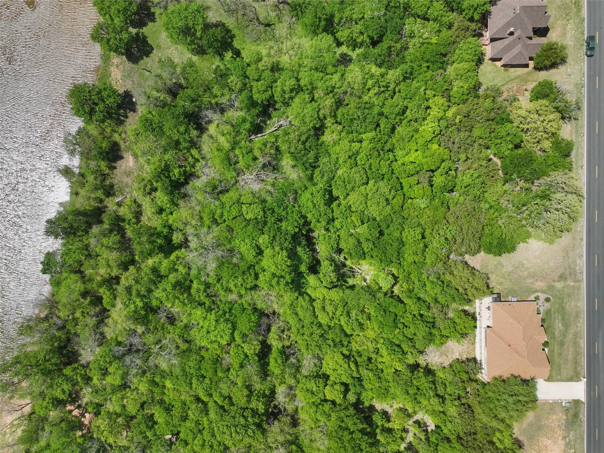 Top-down aerial showing full lot depth from road to river.