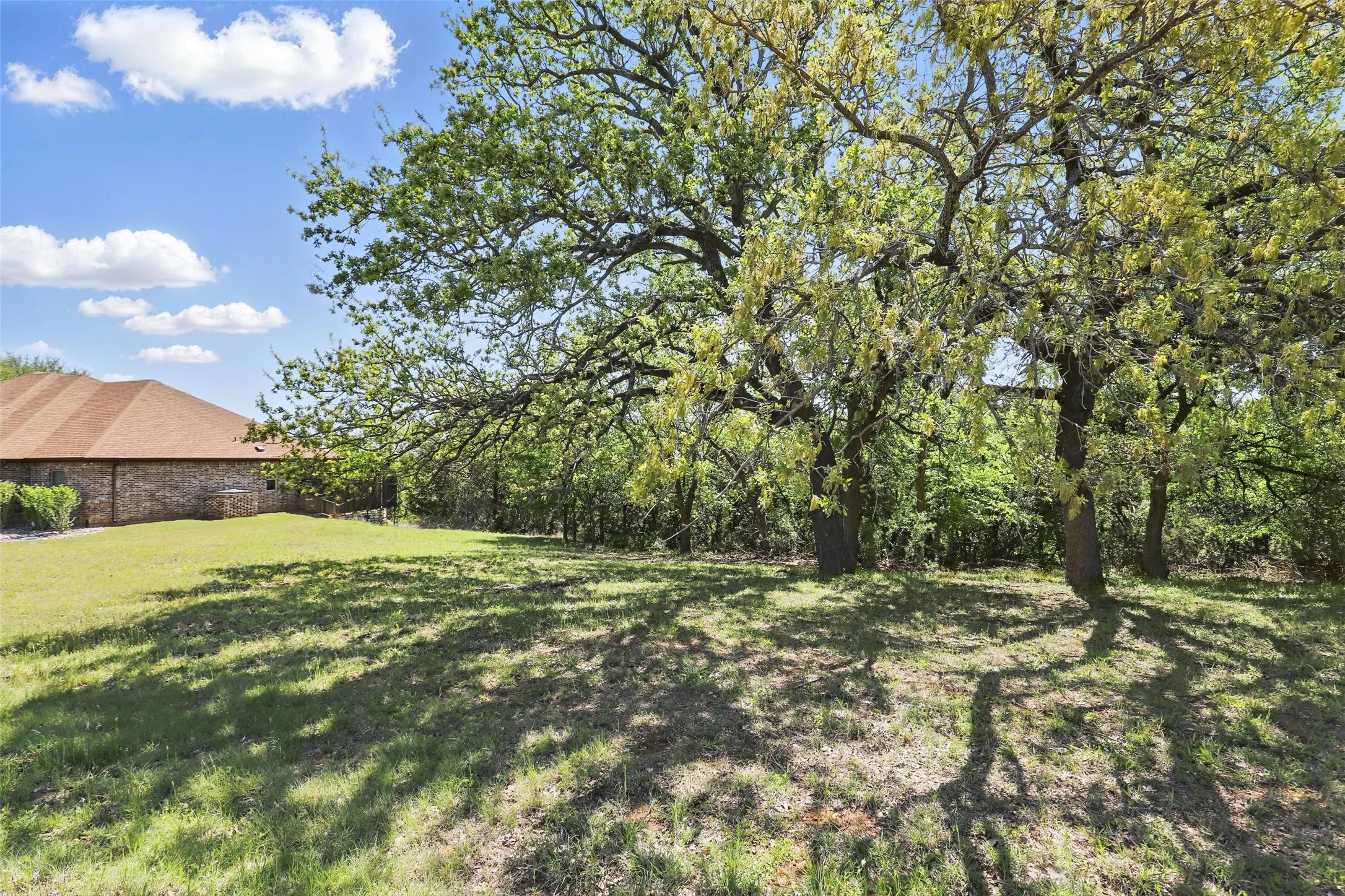 Established trees and natural landscape create a private riverfront setting.