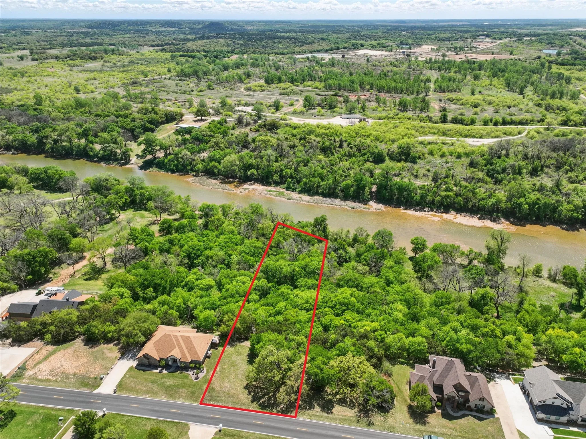 Aerial view highlighting riverfront location and surrounding natural landscape.