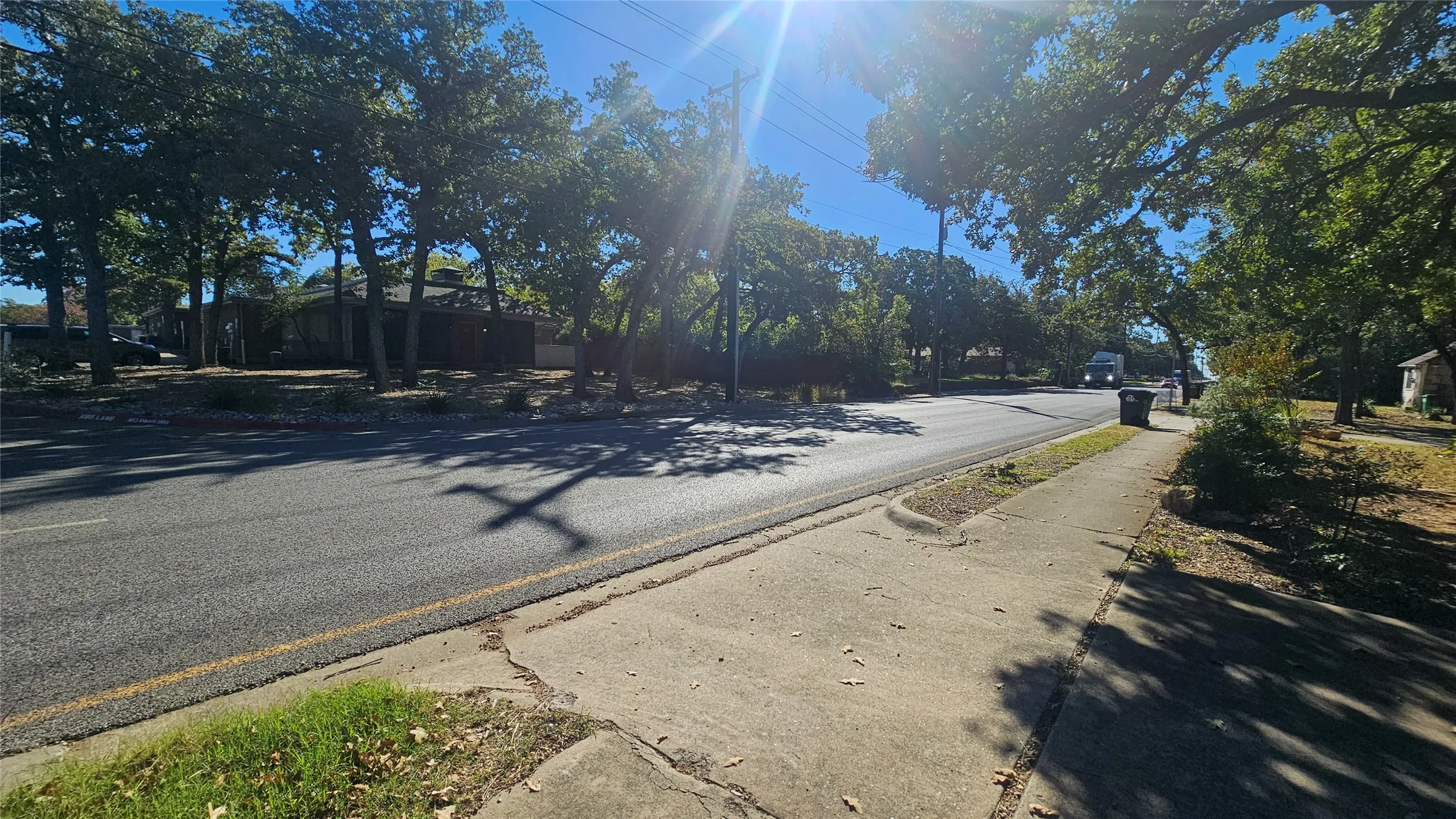 View of asphalt street with sidewalks and curbs