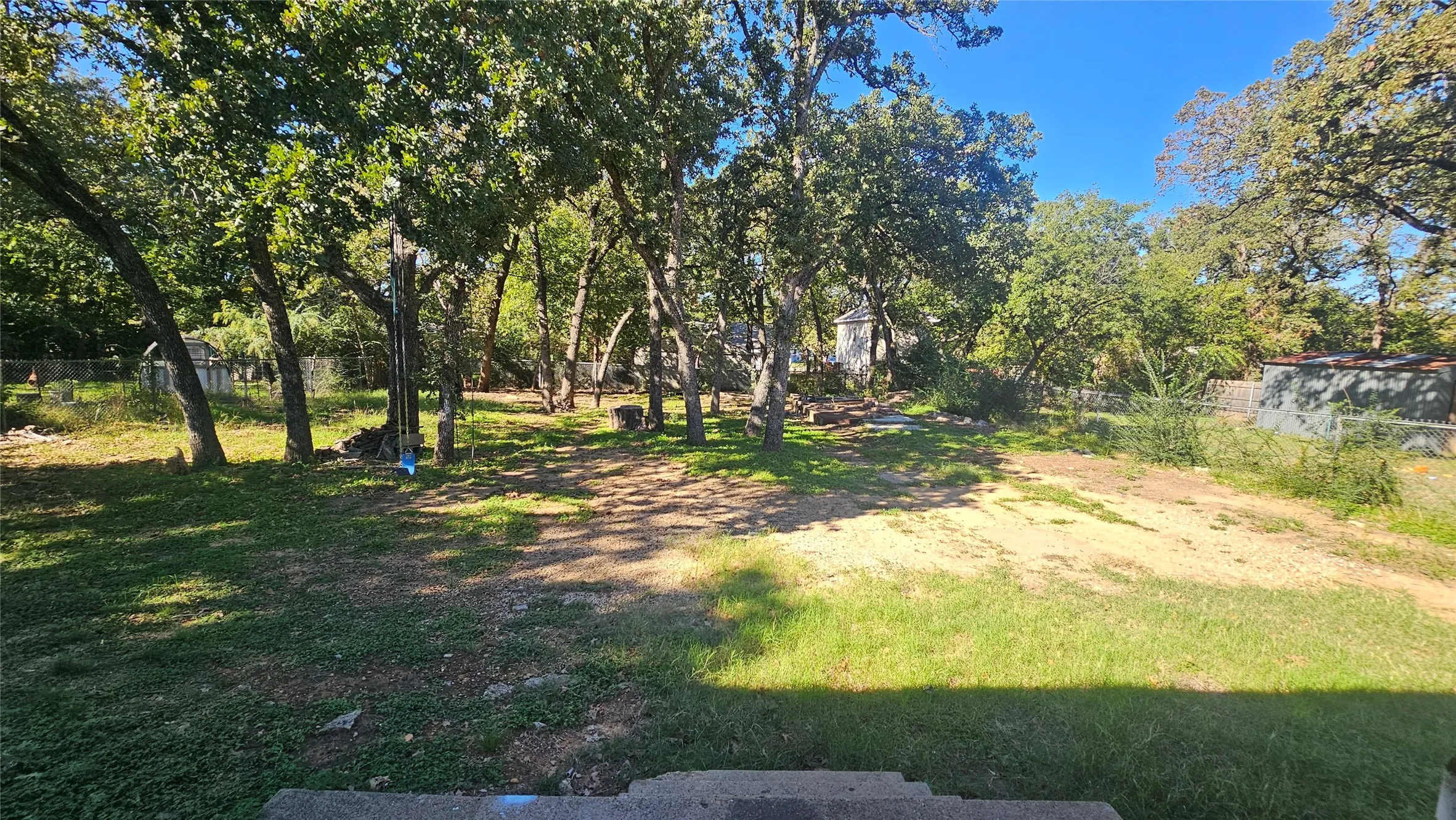 View of yard with view of wooded area