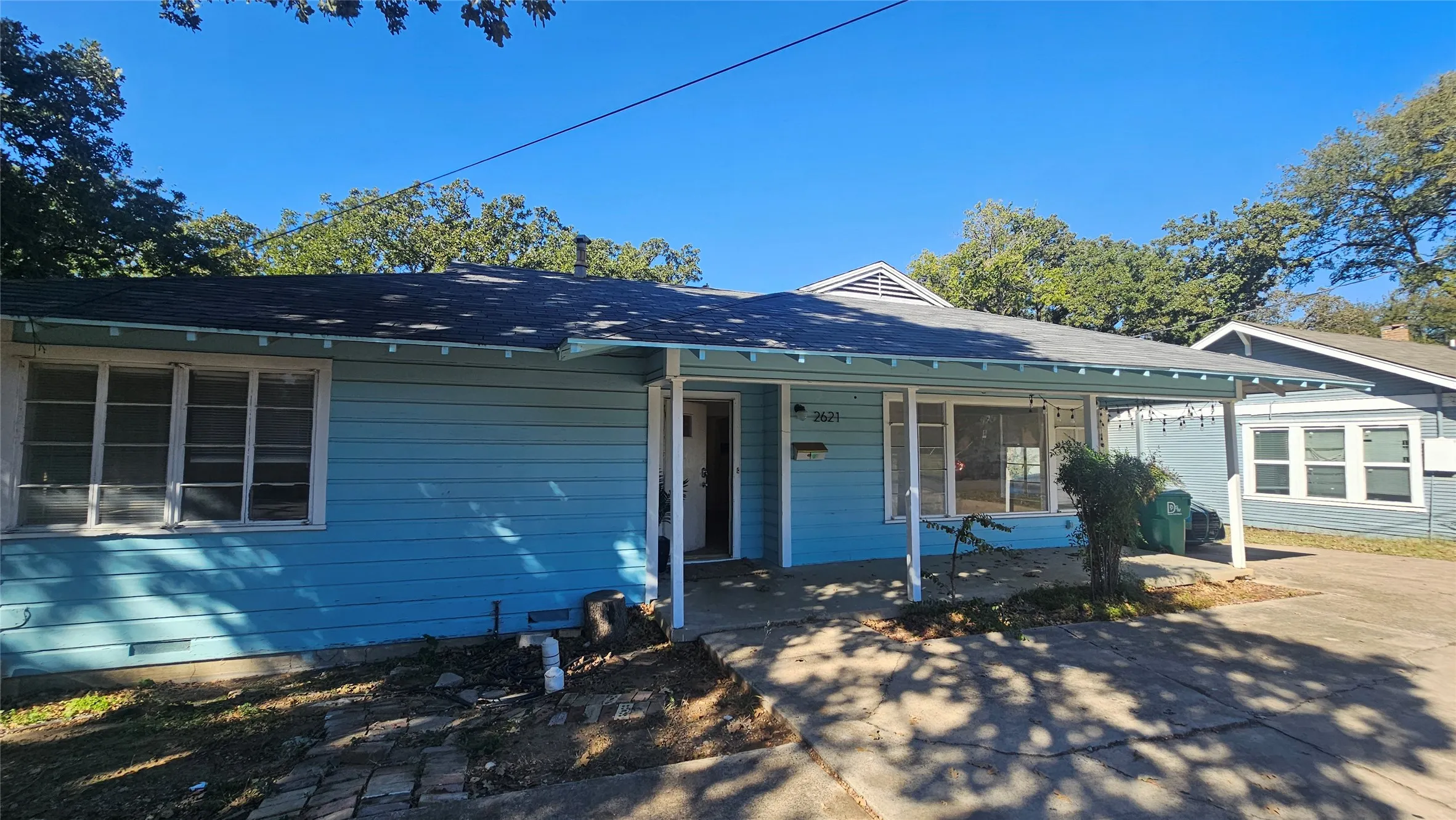 View of front of house featuring covered porch and roof with shingles