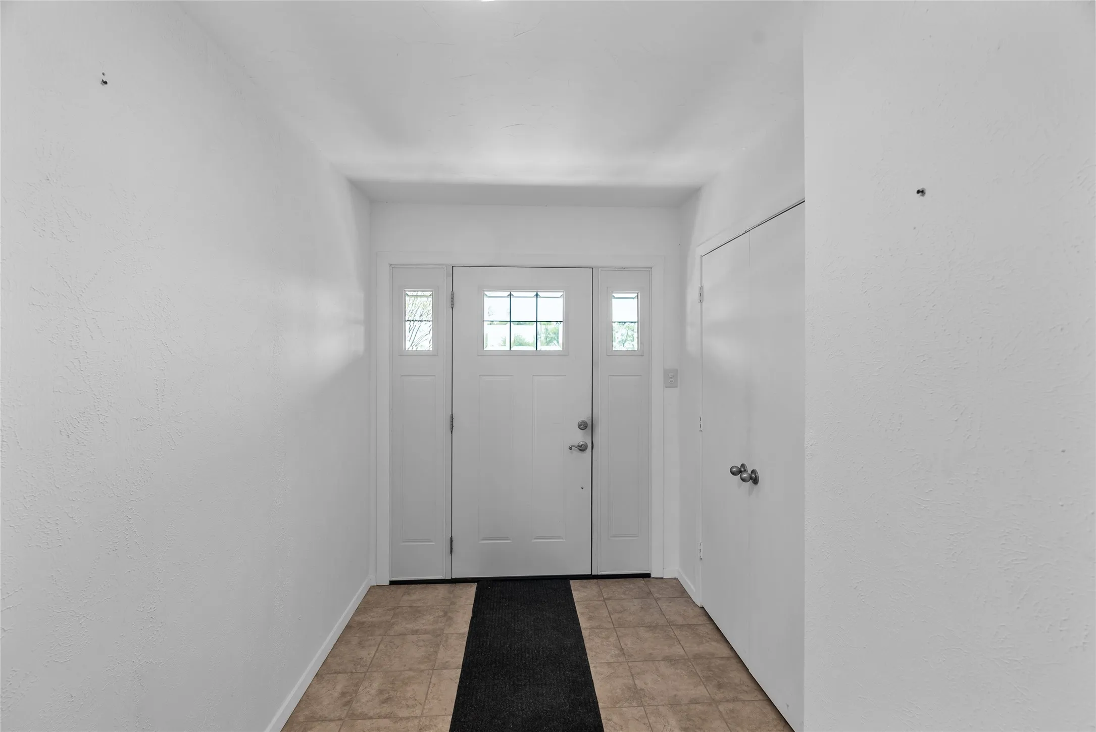 Entrance foyer featuring baseboards