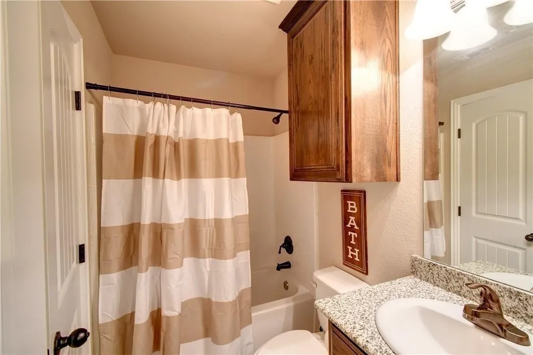 Ensuite bathroom, tub, shower, wood cabinets, and lots of light