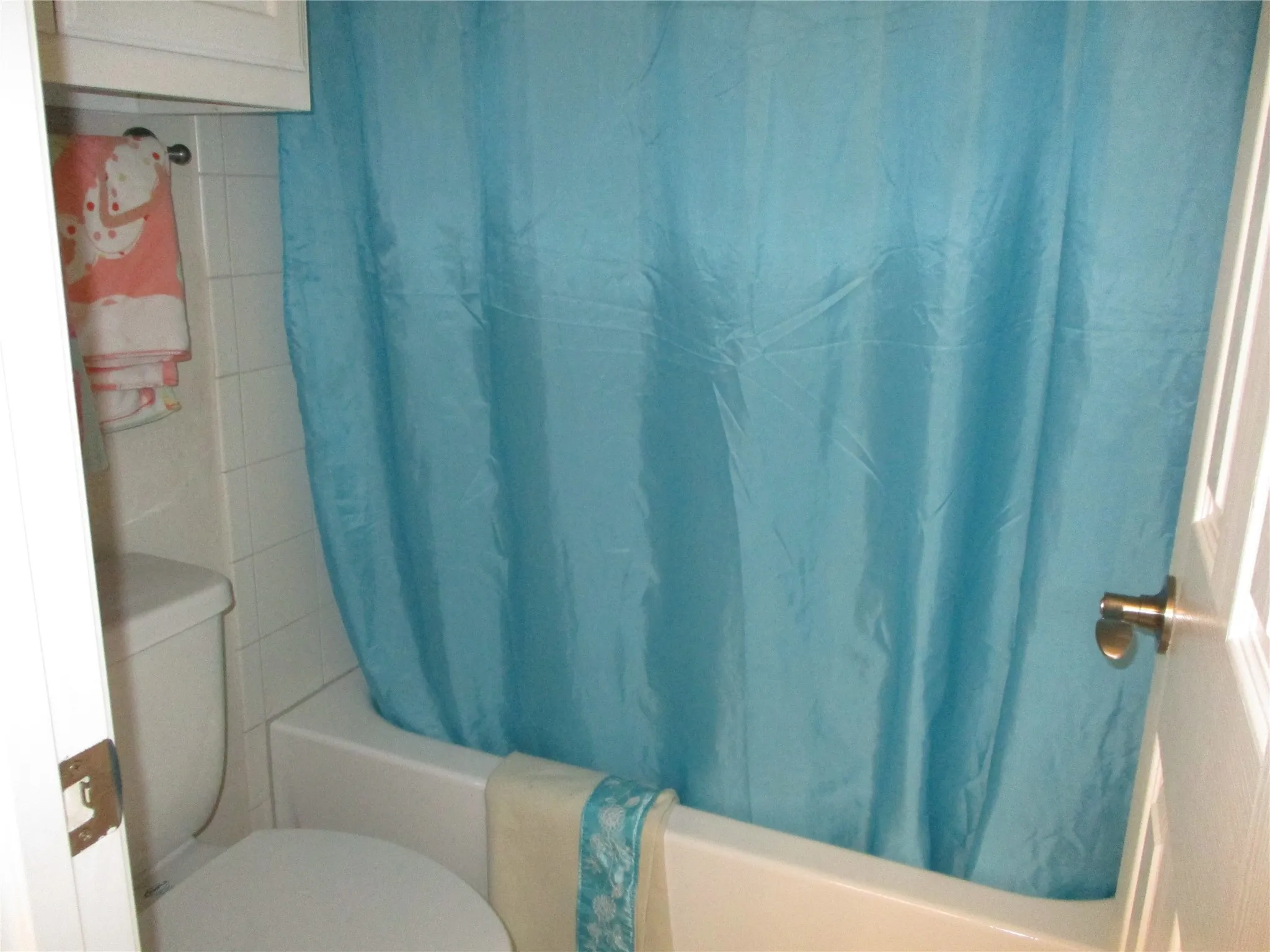 Full bath featuring shower / bath combo and toilet