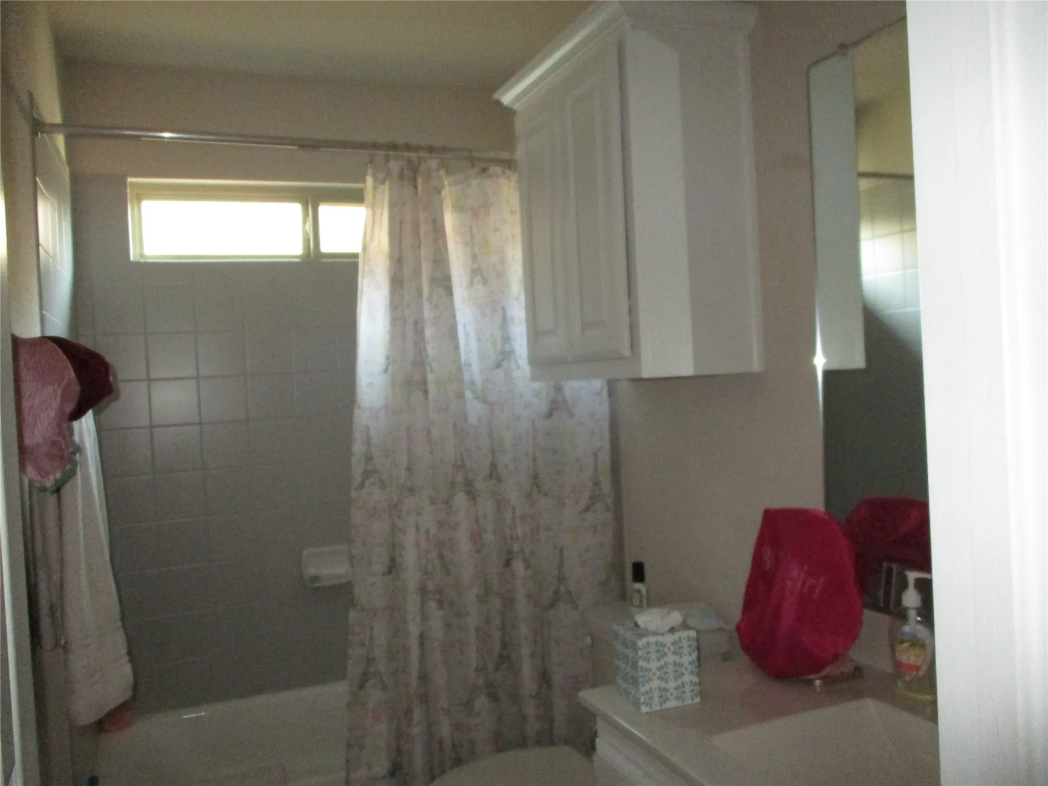Bathroom featuring toilet and a shower with curtain
