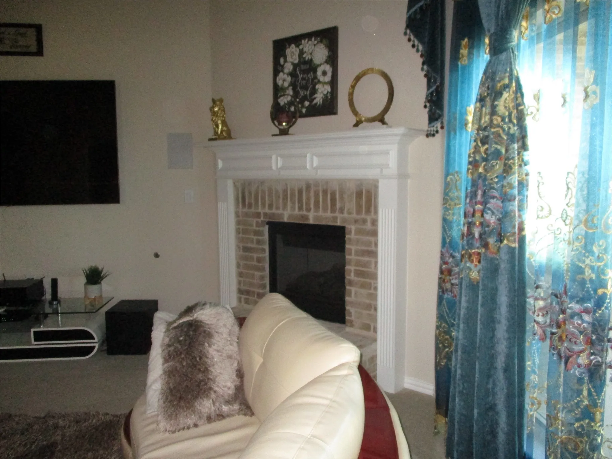Carpeted living room featuring a fireplace