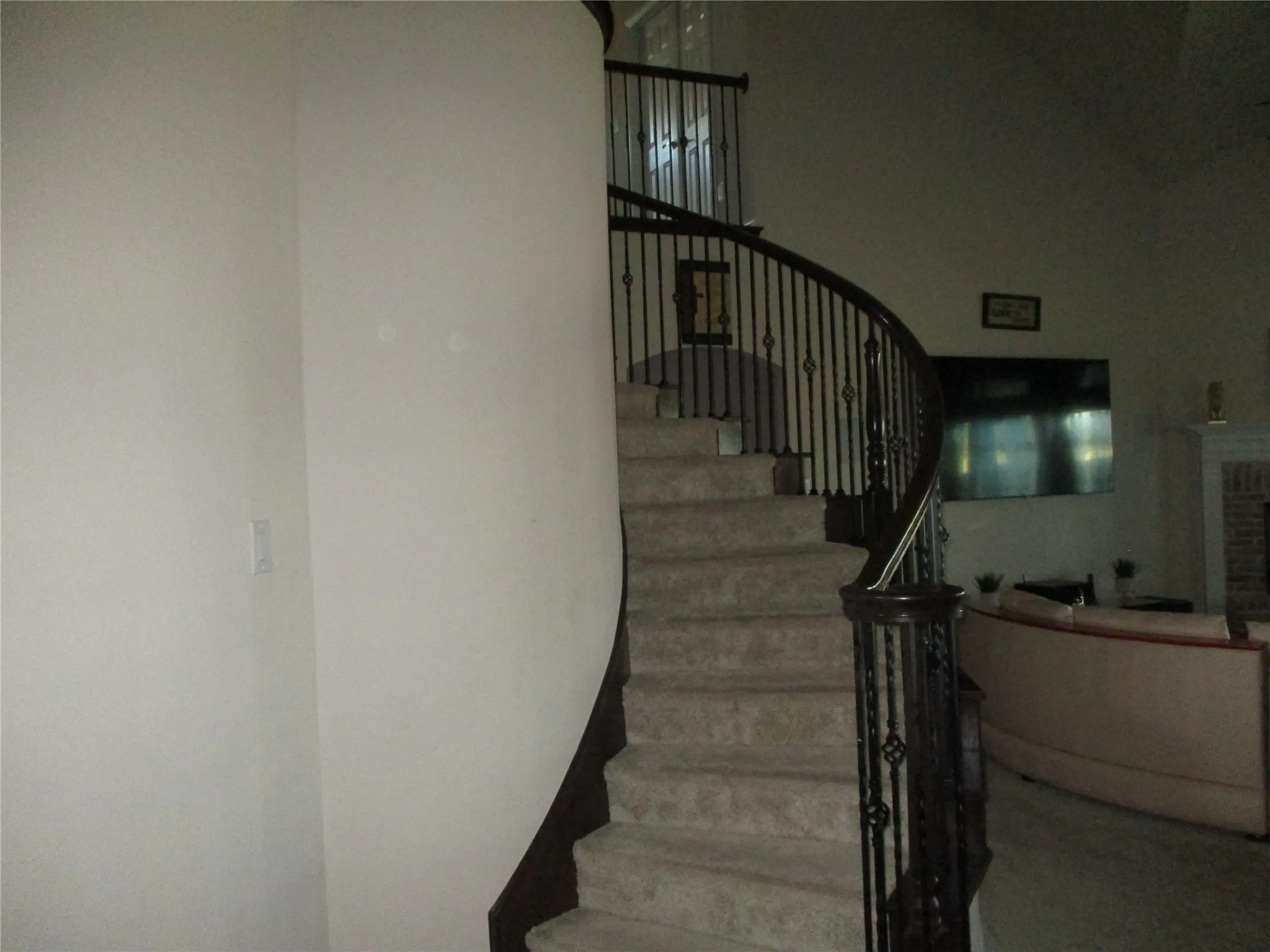 Staircase with a brick fireplace