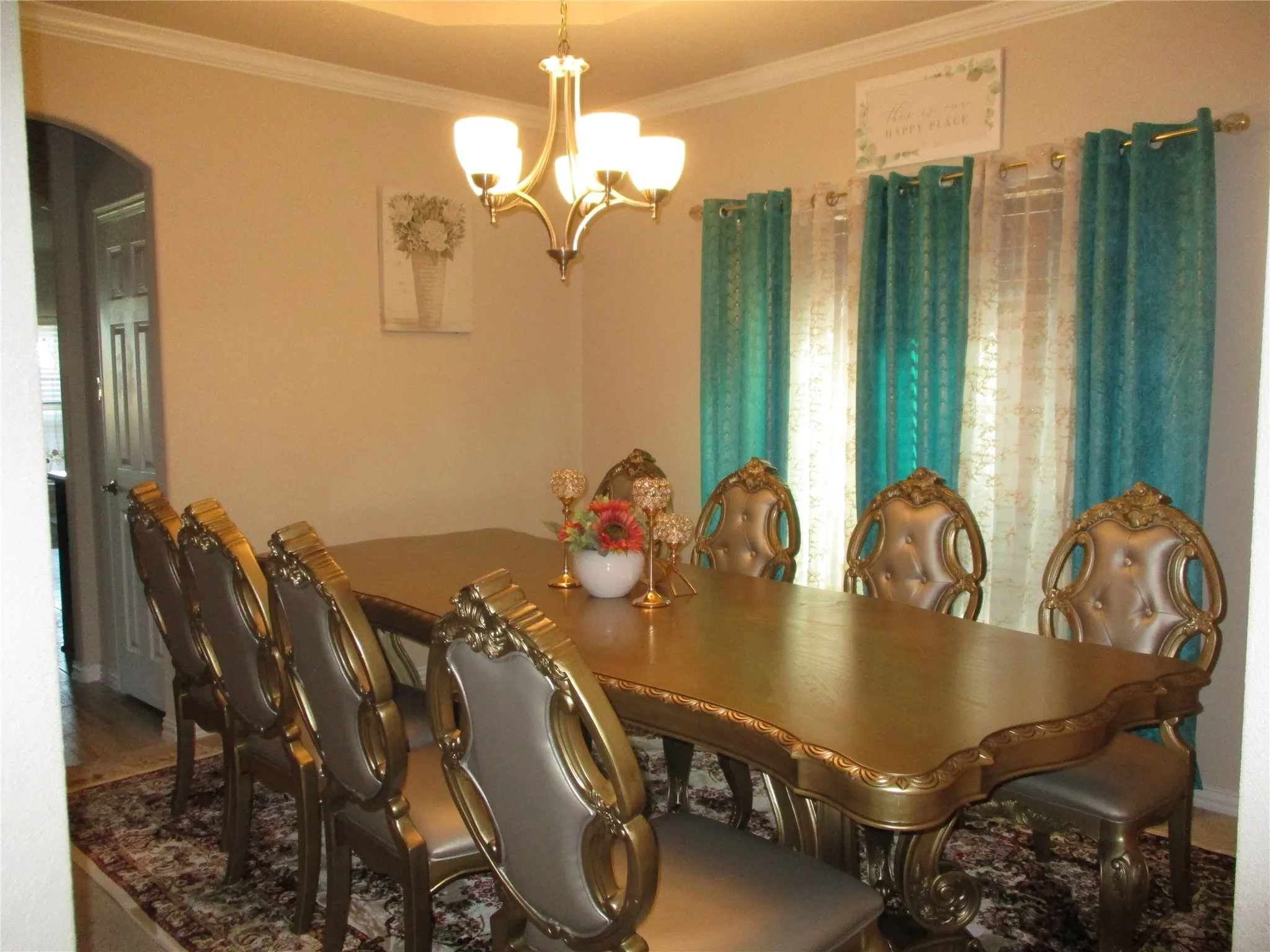 Dining area featuring a wealth of natural light, arched walkways, a notable chandelier, and crown molding