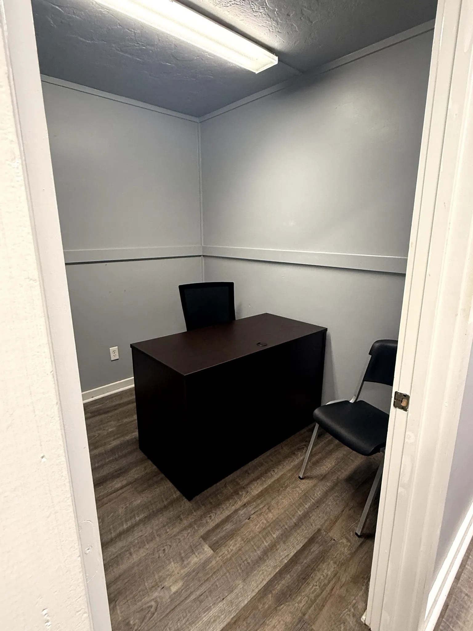 Wood-finish flooring with a neutral wall color and crown molding