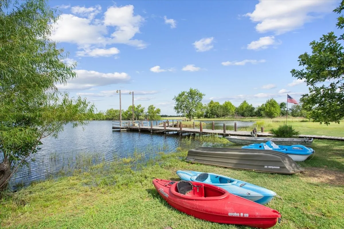 Dock area featuring a water view and a yard