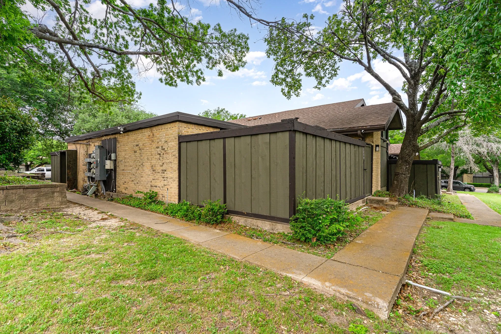 View of side of property featuring brick siding