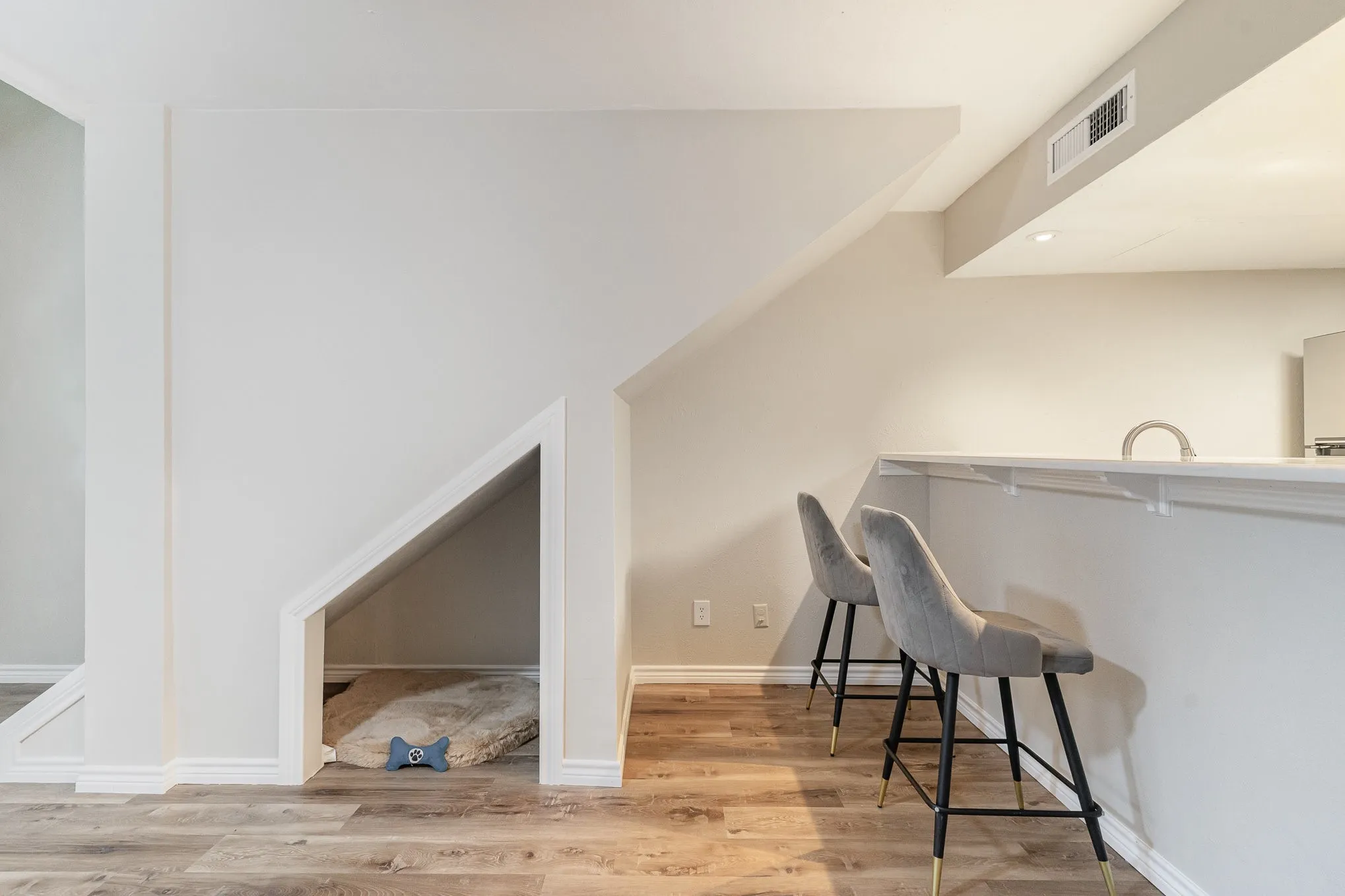 Bar with wood finished floors, visible vents, and baseboards