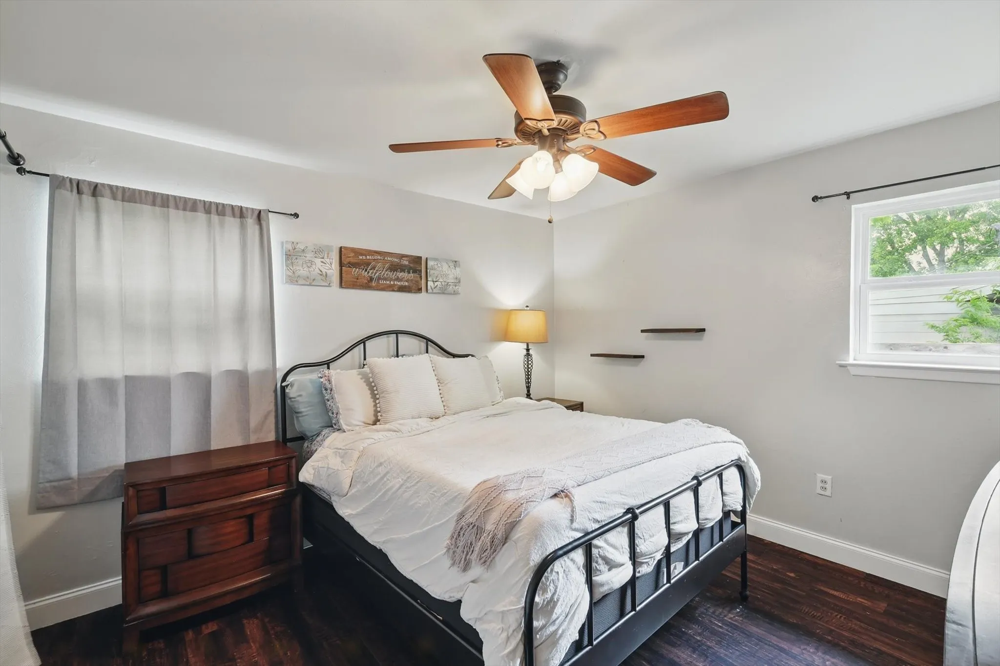 Bedroom featuring baseboards, ceiling fan, and wood finished floors
