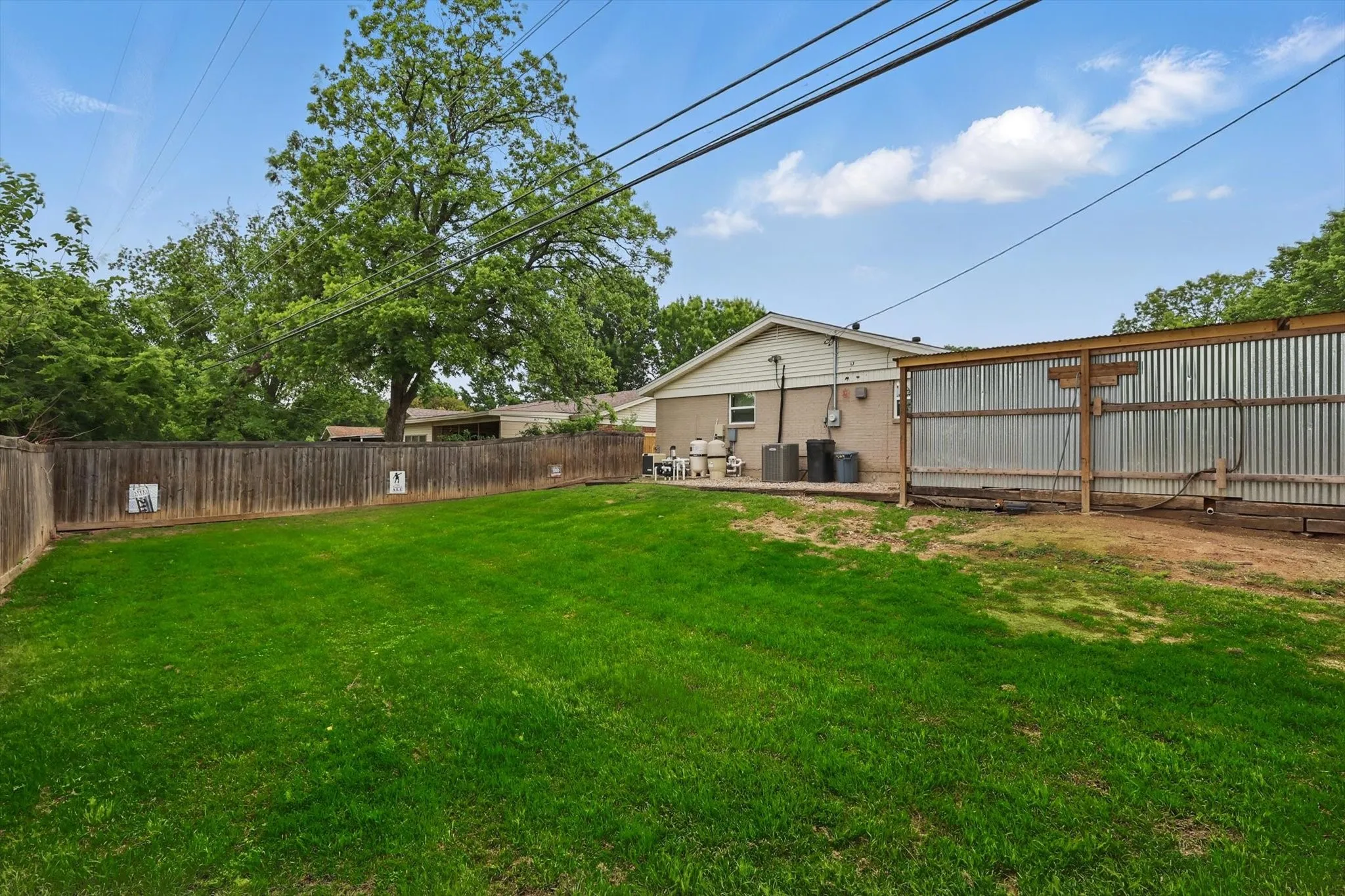 View of yard featuring a fenced backyard and central air condition unit