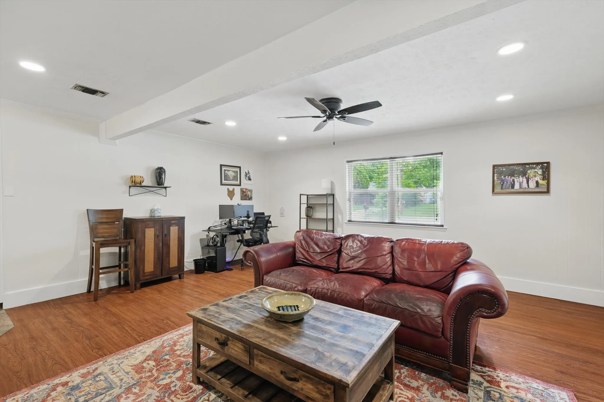 Living room with baseboards, recessed lighting, wood finished floors, and visible vents