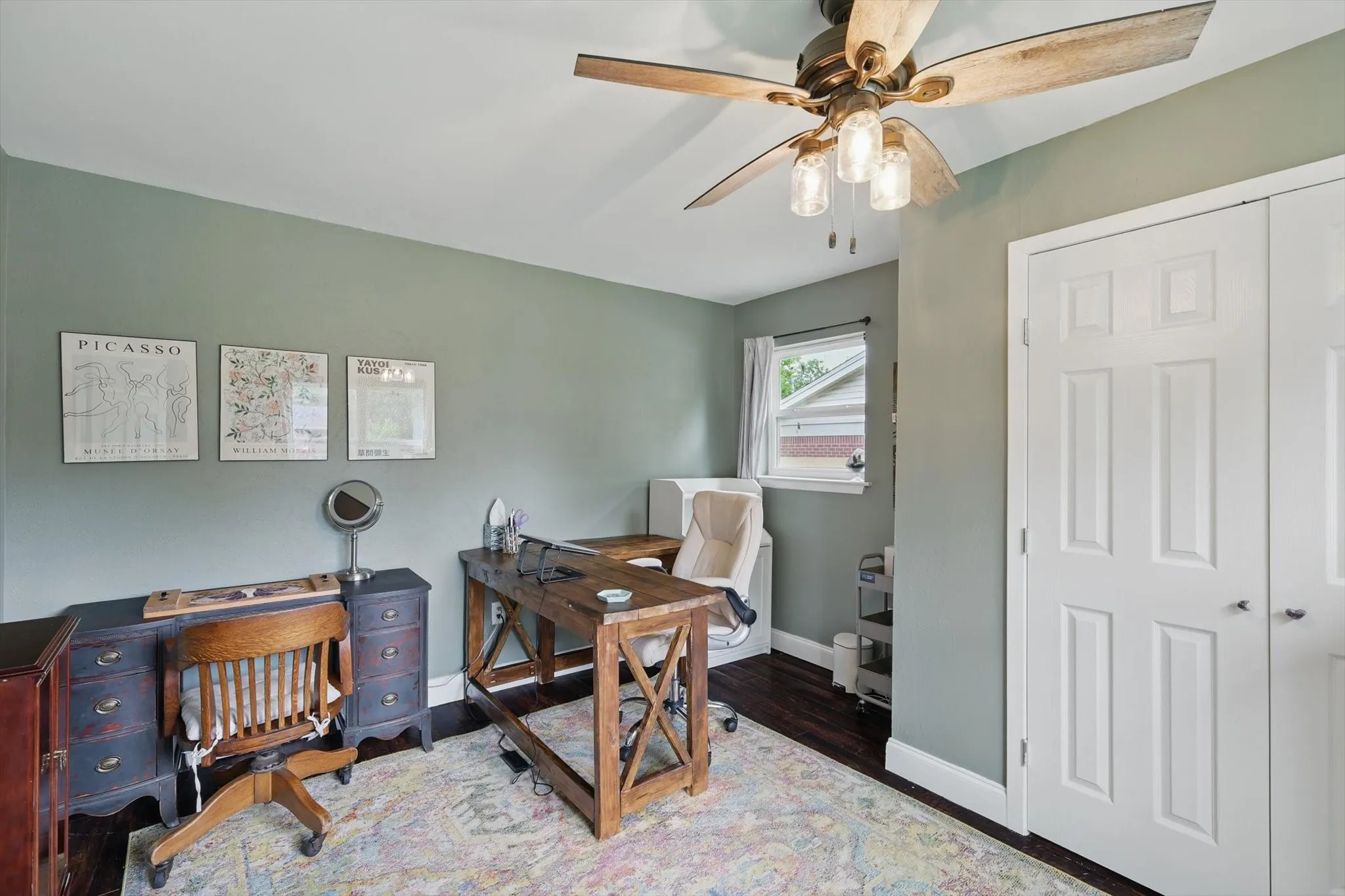 Office space with baseboards, ceiling fan, and wood finished floors