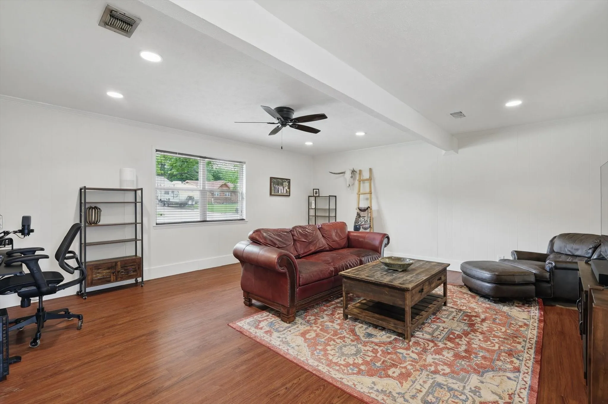 Living room featuring visible vents, wood finished floors, beamed ceiling, recessed lighting, and a ceiling fan