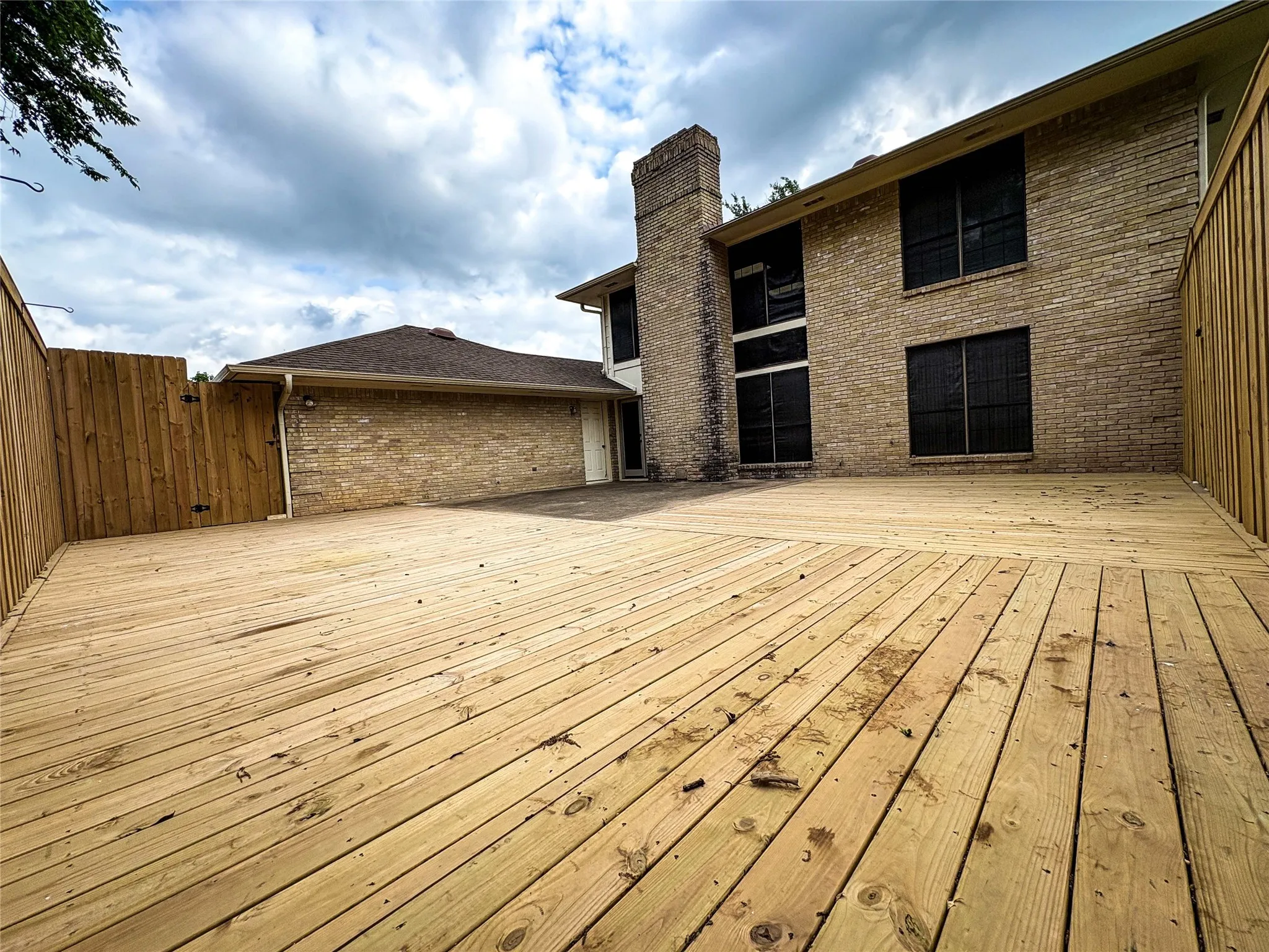 BACK VIEW OF HOME WITH RECENTLY INSTALLED DECK