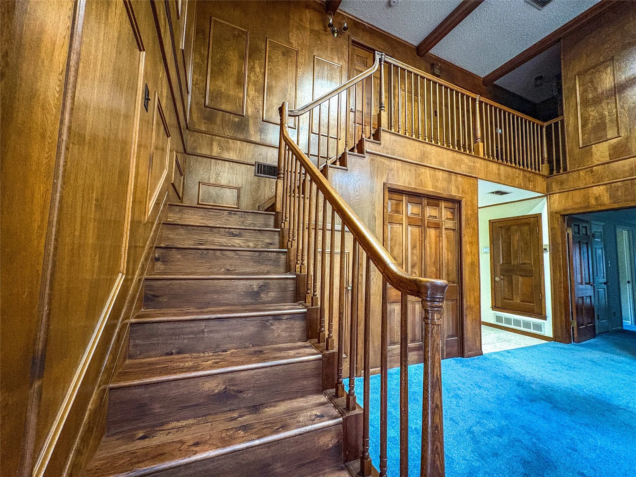 WIDE OPEN STAIRS TO THE GUEST BEDROOMS AND BATH