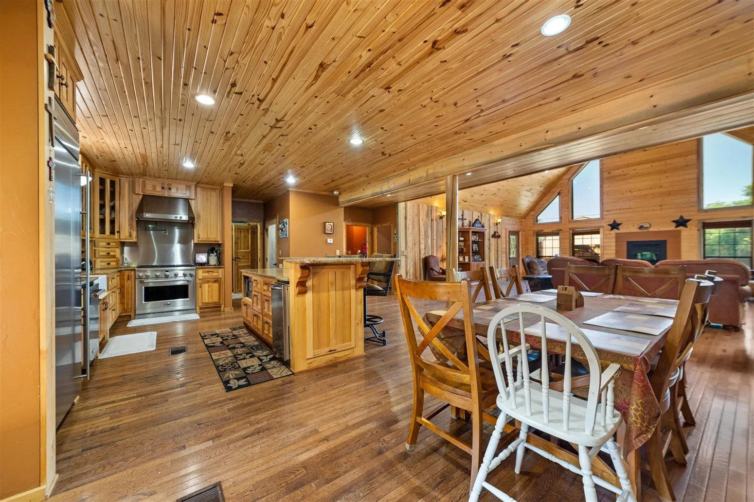 Dining room with hardwood / wood-style flooring, wooden ceiling, and recessed lighting