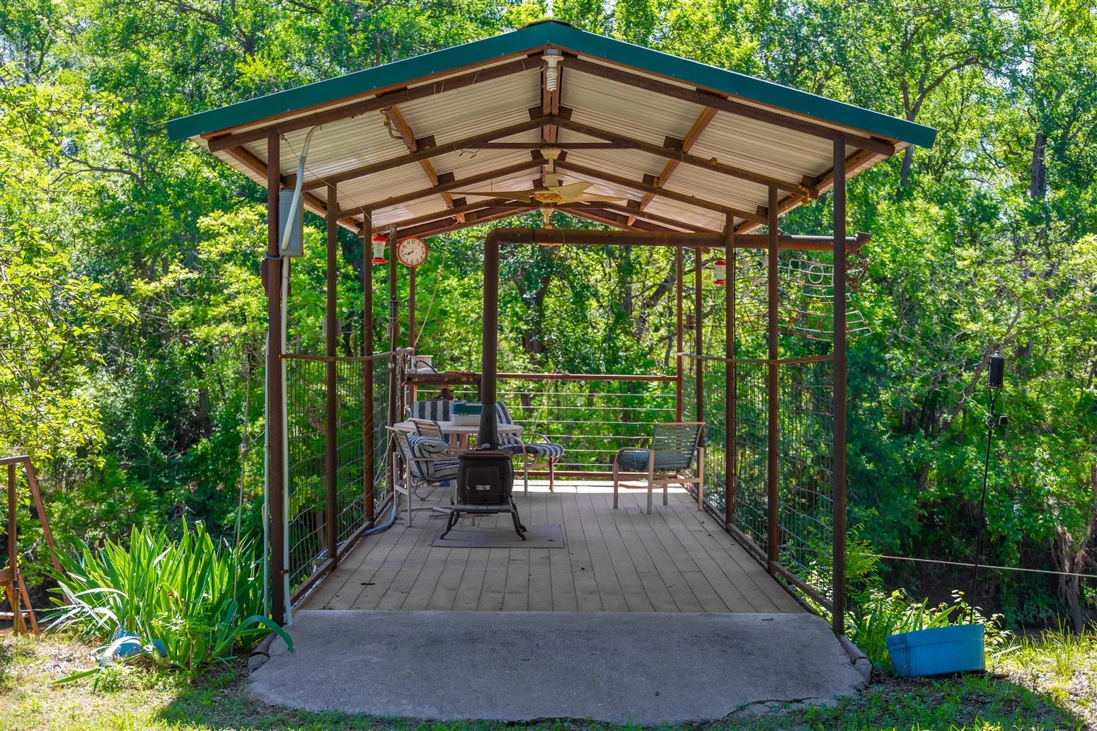 Wooden deck featuring a gazebo and ceiling fan