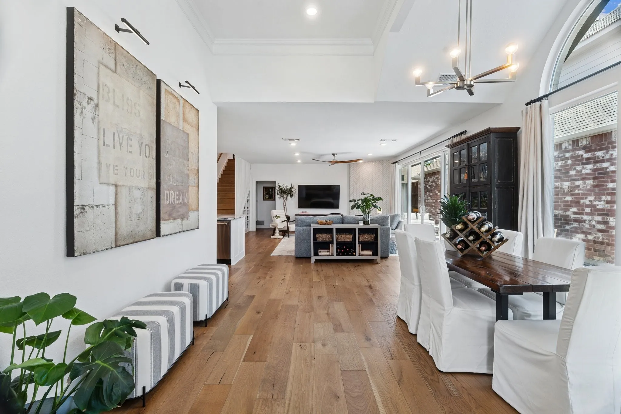 Dining room featuring wood-type flooring, recessed lighting, a ceiling fan, and a chandelier