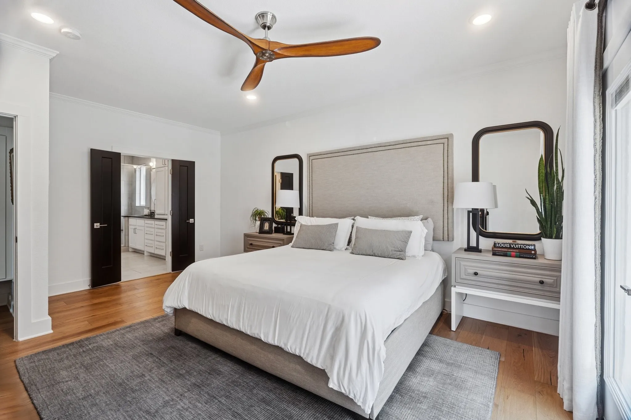 Bedroom with wood finished floors, crown molding, recessed lighting, connected bathroom, and ceiling fan