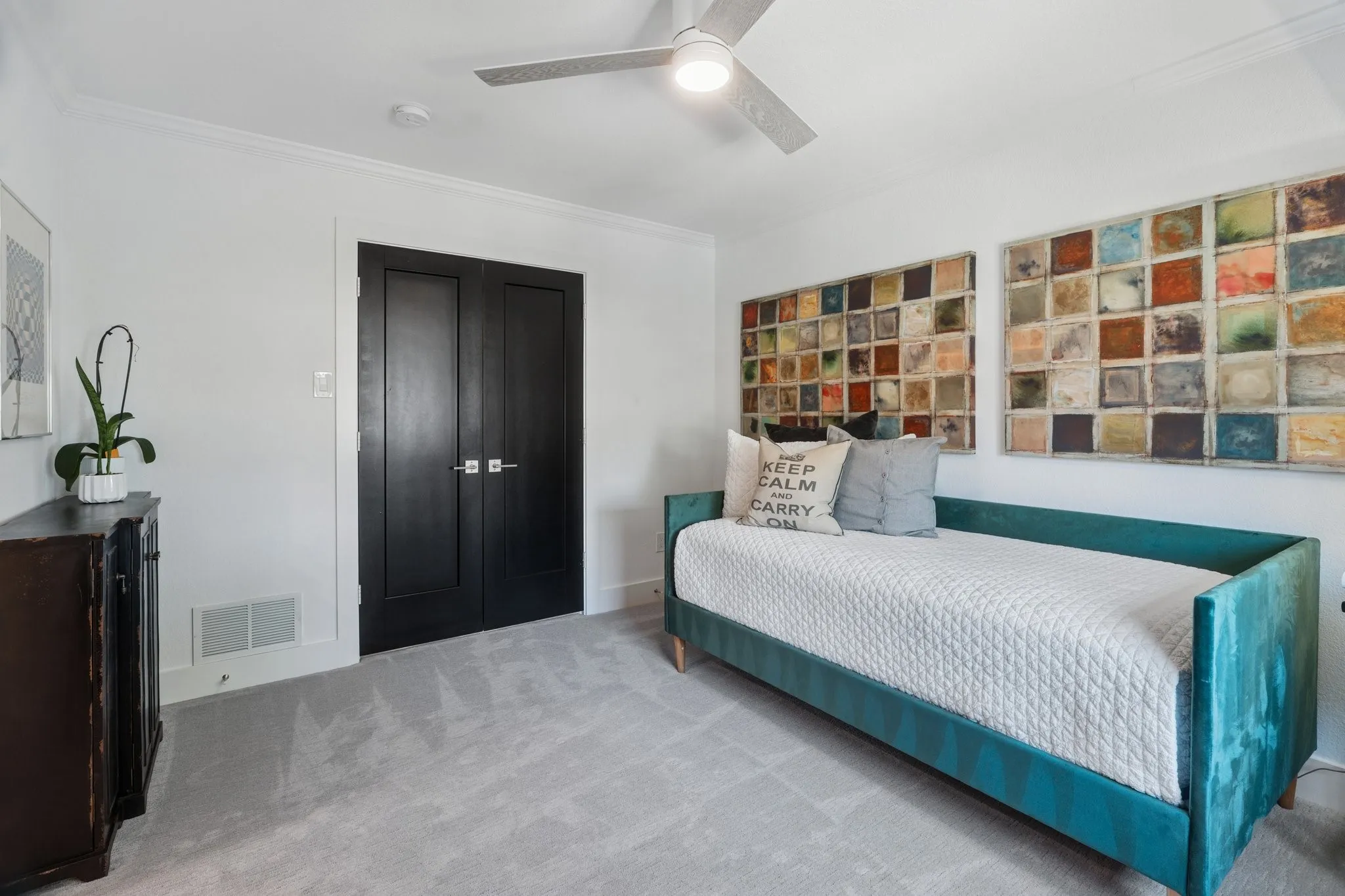 Carpeted bedroom featuring crown molding, a closet, and a ceiling fan
