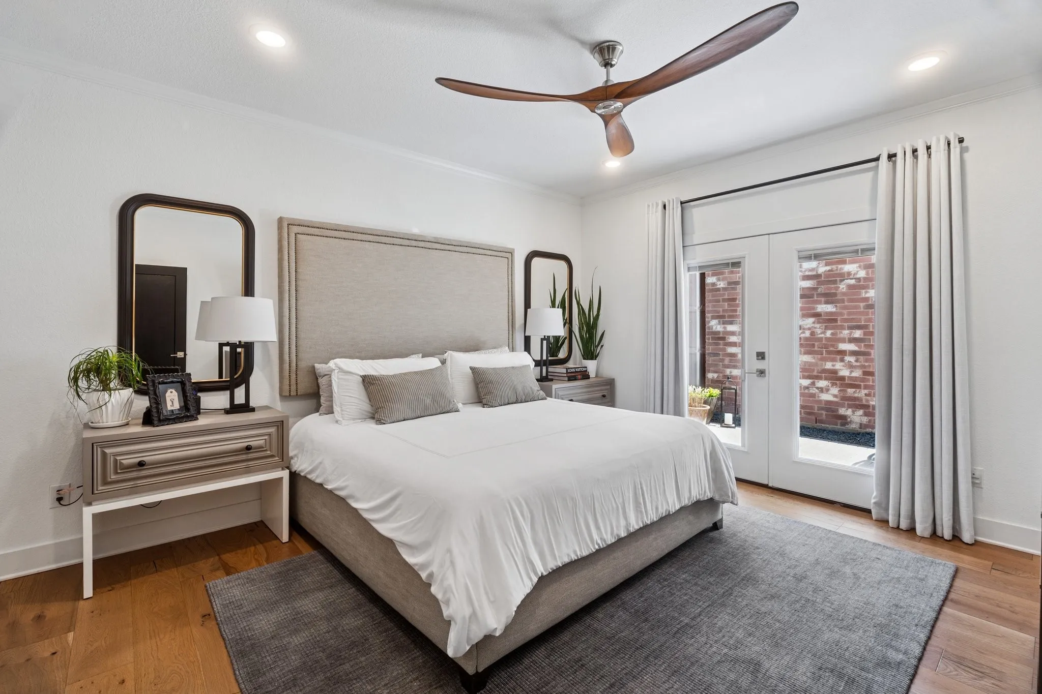 Bedroom featuring access to outside, french doors, light wood-style flooring, crown molding, and recessed lighting