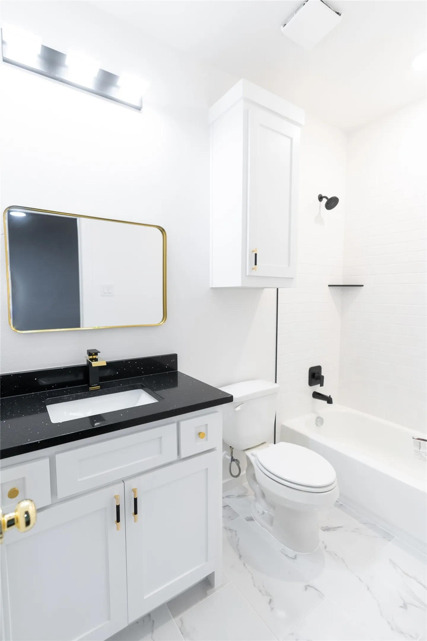 Bathroom with tub / shower combination, toilet, vanity, and marble finish floor