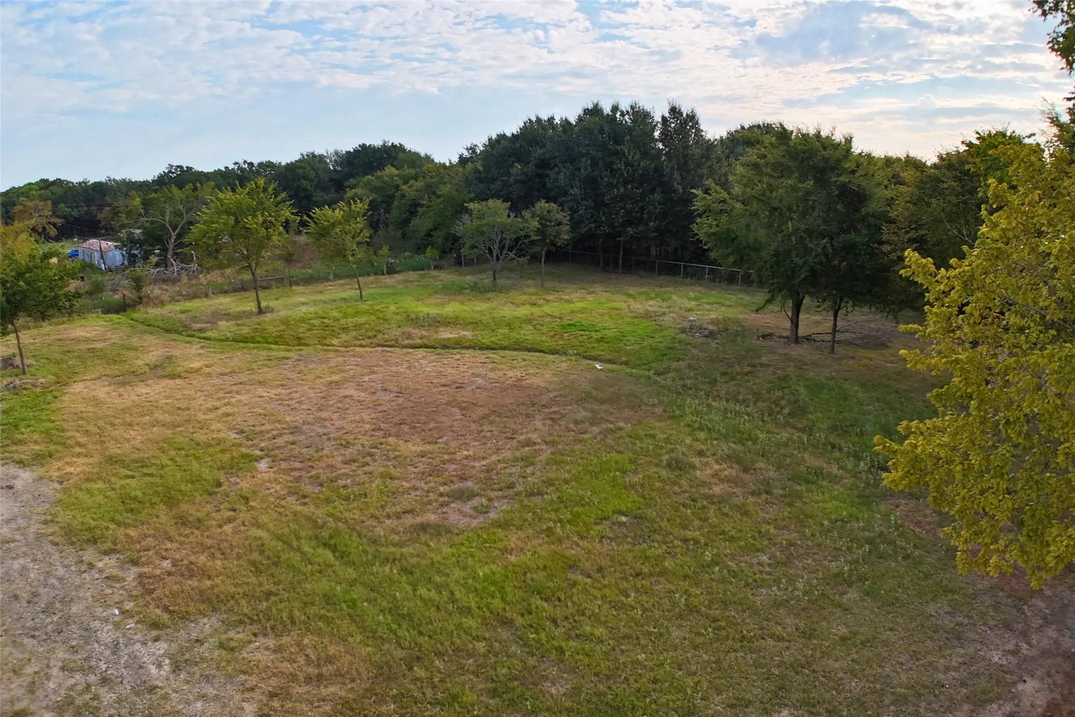 View of yard featuring fence and a rural view