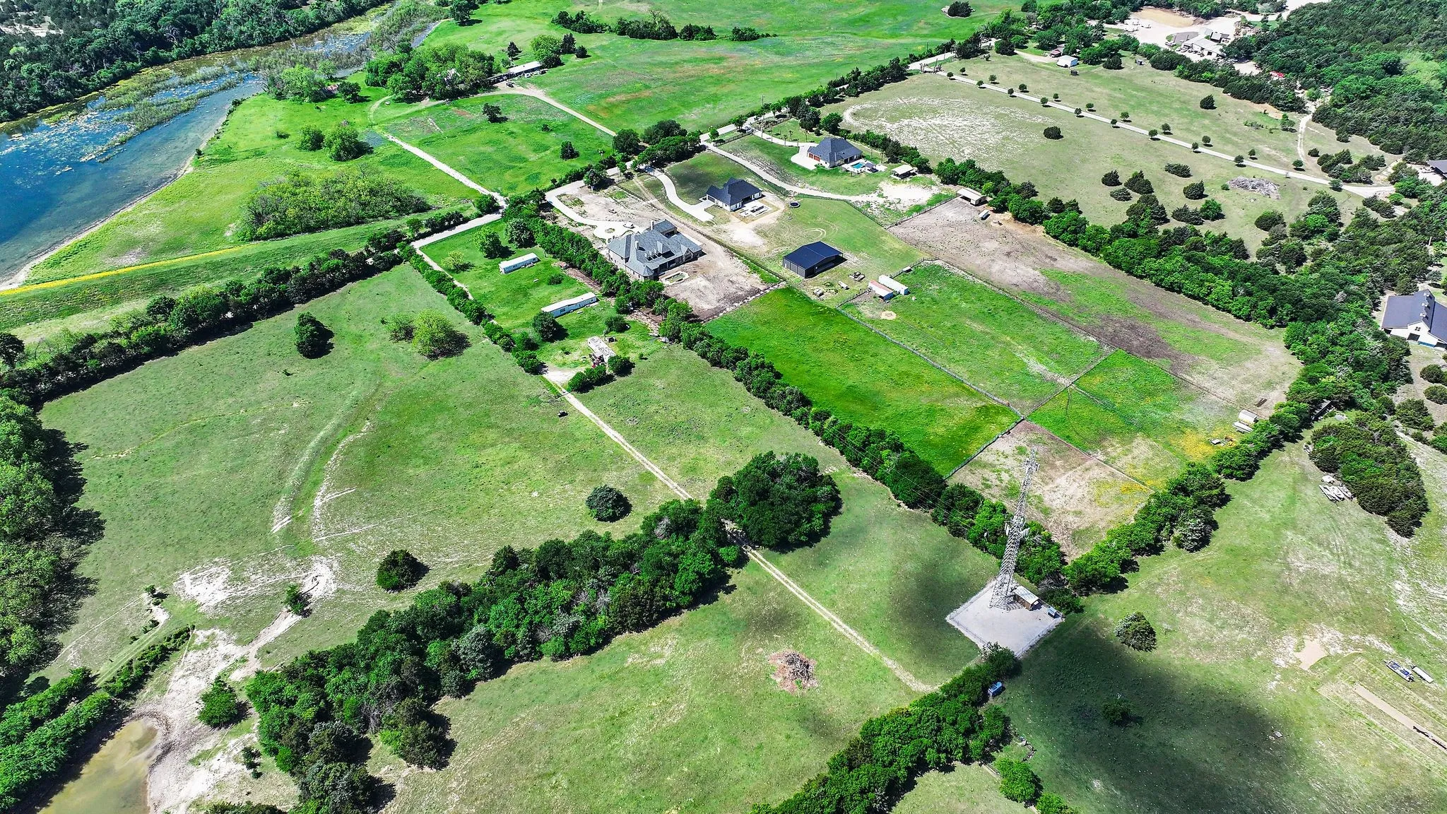 Birds eye view of property with a water view and a rural view