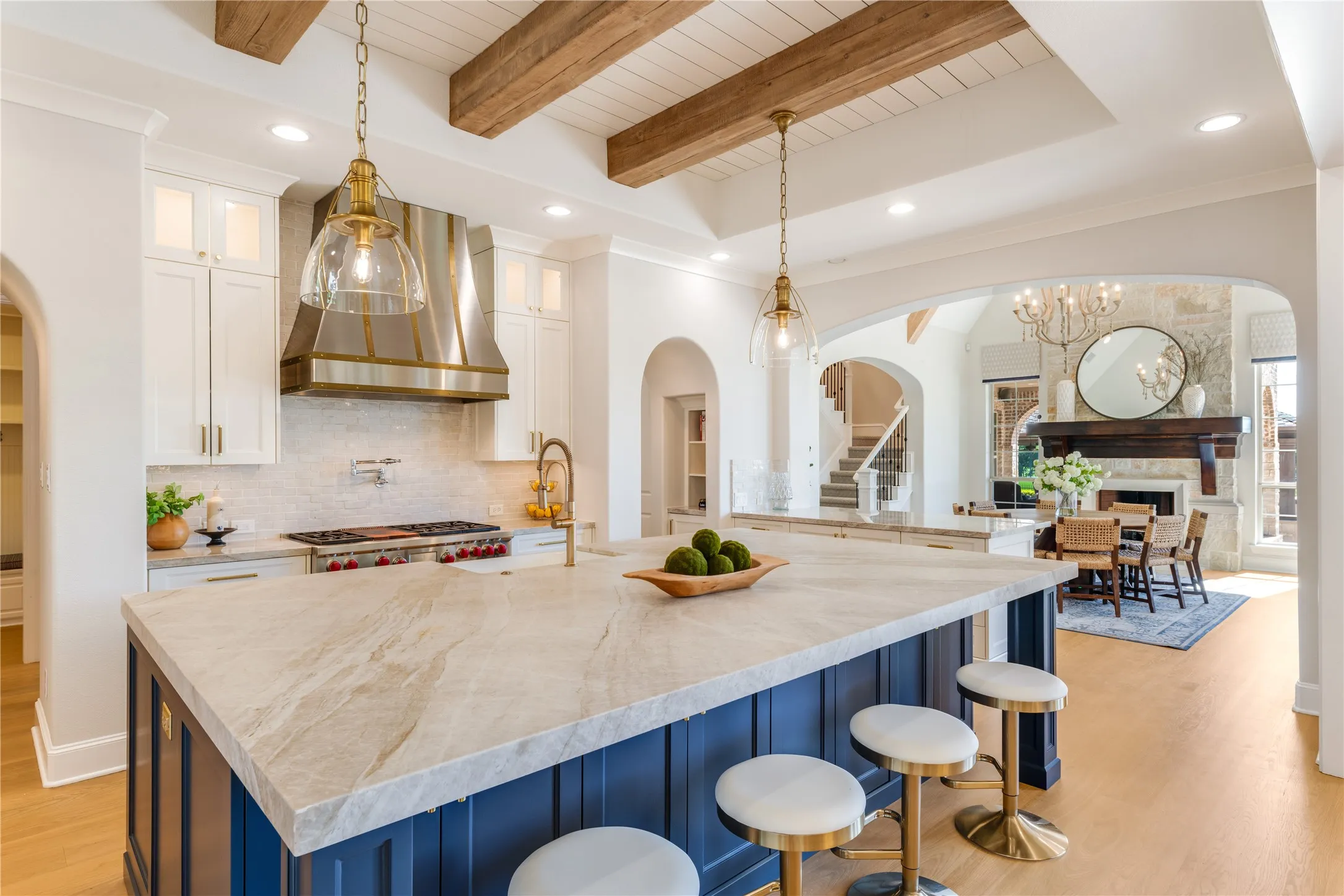 A marvelous kitchen complex for the serious gourmet. Quartzite Taj Mahal countertops, hand-painted backsplash tiles, ultra large island with classic pendants & custom soft close Maple cabinets with kiln-dried paint that's ultra durable.