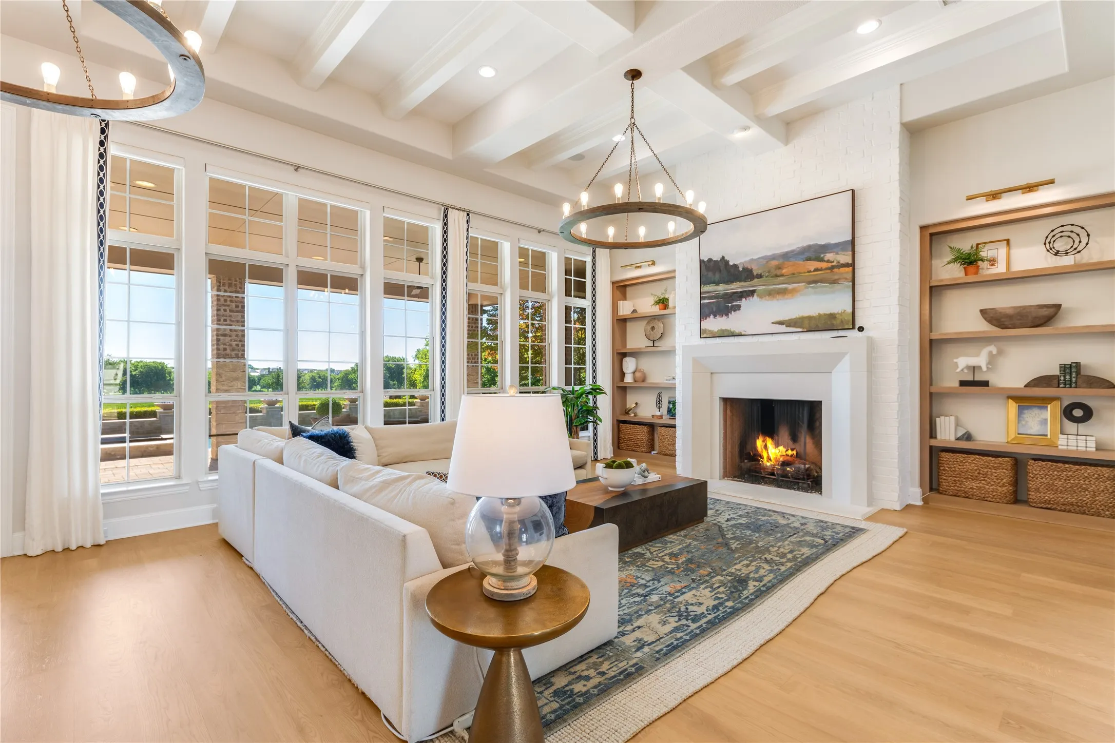 Making the beauty of the outdoors an integral part of its design, this living room offers a multitude of furniture placment options. Among the many smart home features are the automated blinds to let in light or lower for privacy + convenient automated light switches.