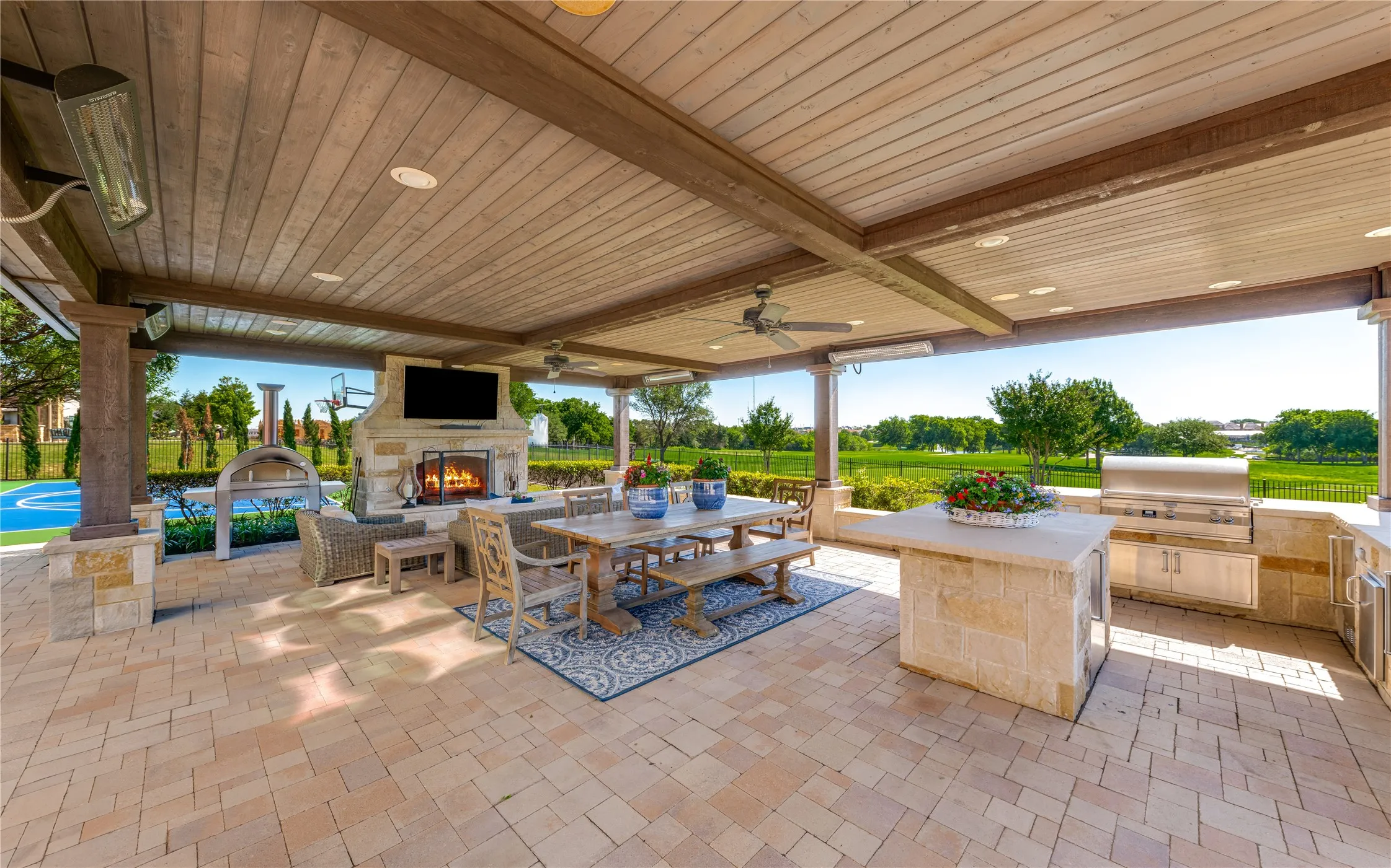 Entertaining al fresco is a dream under the outdoor pavilion. Whether you're sipping a nightcap by the warm fire or serving up a family meal on the barbecue grill in the outdoor kitchen....plenty of room to host many gatherings. Note the four built-in space heaters & impressive storage in the outdoor kitchen.