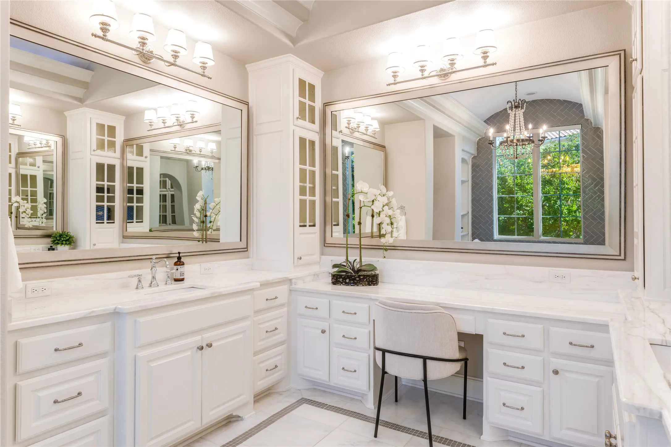 Sparkling clean, the tray ceiling & designer lighting offer a light-filled spaciousness to the primary bathroom.